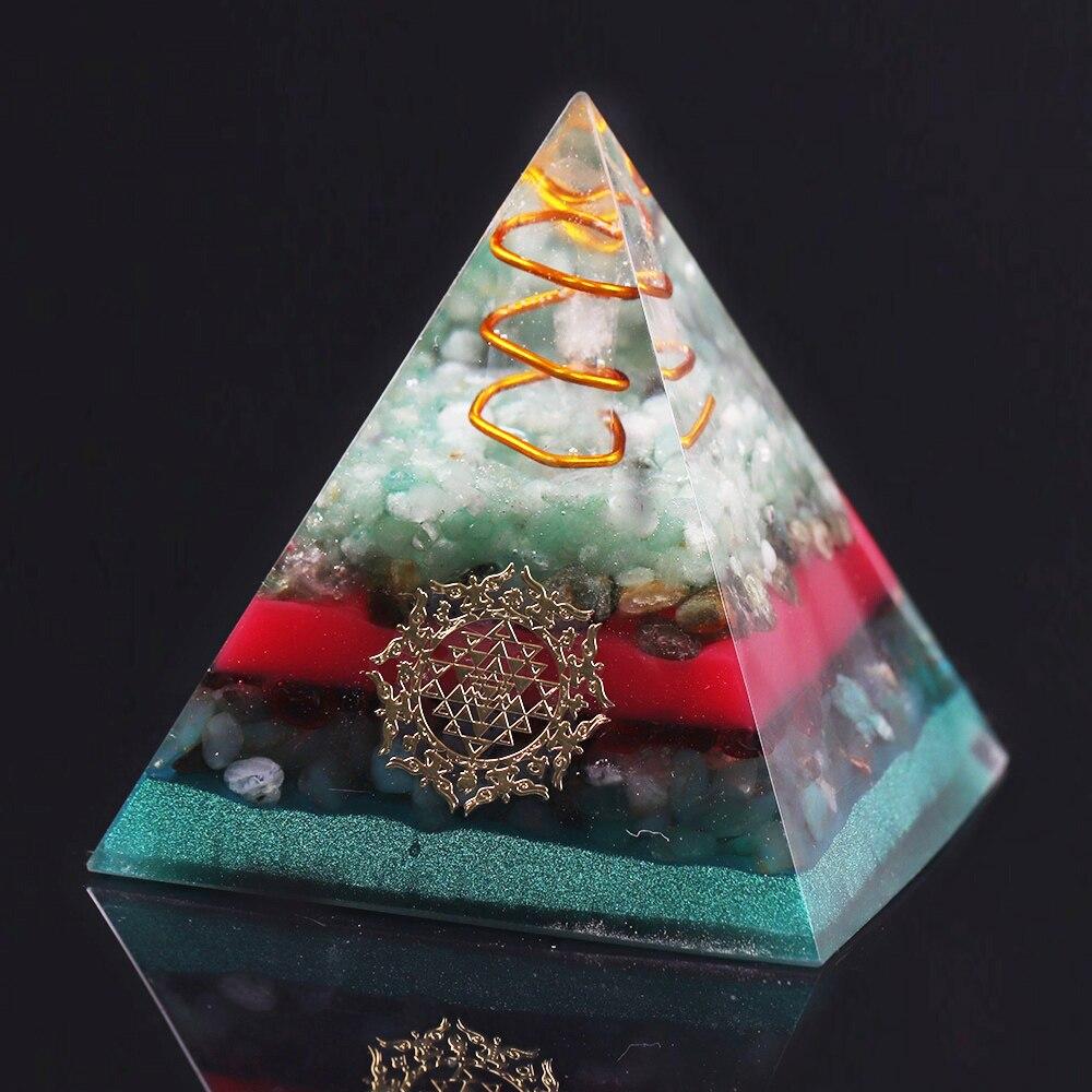 A handcrafted Orgonite Pyramid made from green aventurine, copper, olivine, green agate, and garnet, designed for chakra healing and energy conversion.