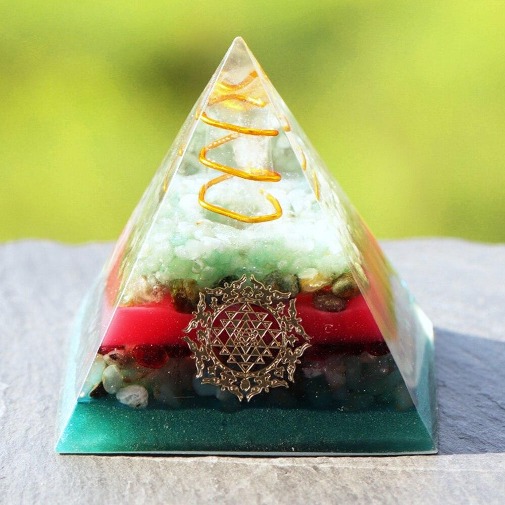 A handcrafted Orgonite Pyramid made from green aventurine, copper, olivine, green agate, and garnet, designed for chakra healing and energy conversion.