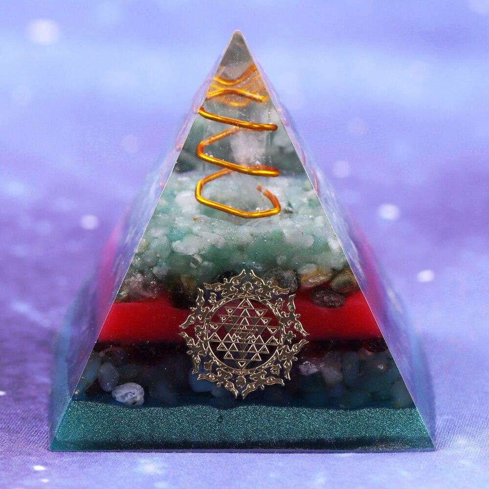 A handcrafted Orgonite Pyramid made from green aventurine, copper, olivine, green agate, and garnet, designed for chakra healing and energy conversion.