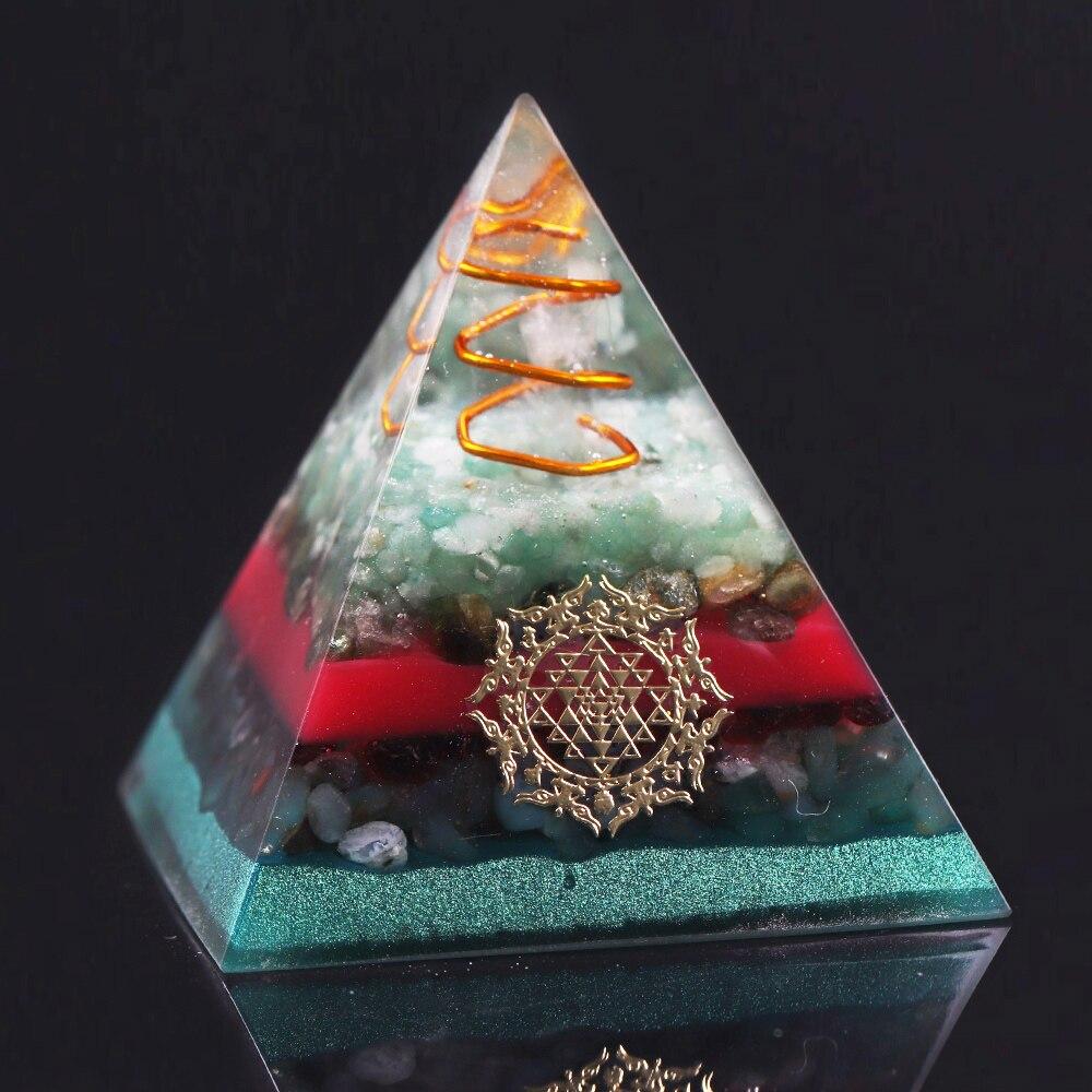 A handcrafted Orgonite Pyramid made from green aventurine, copper, olivine, green agate, and garnet, designed for chakra healing and energy conversion.