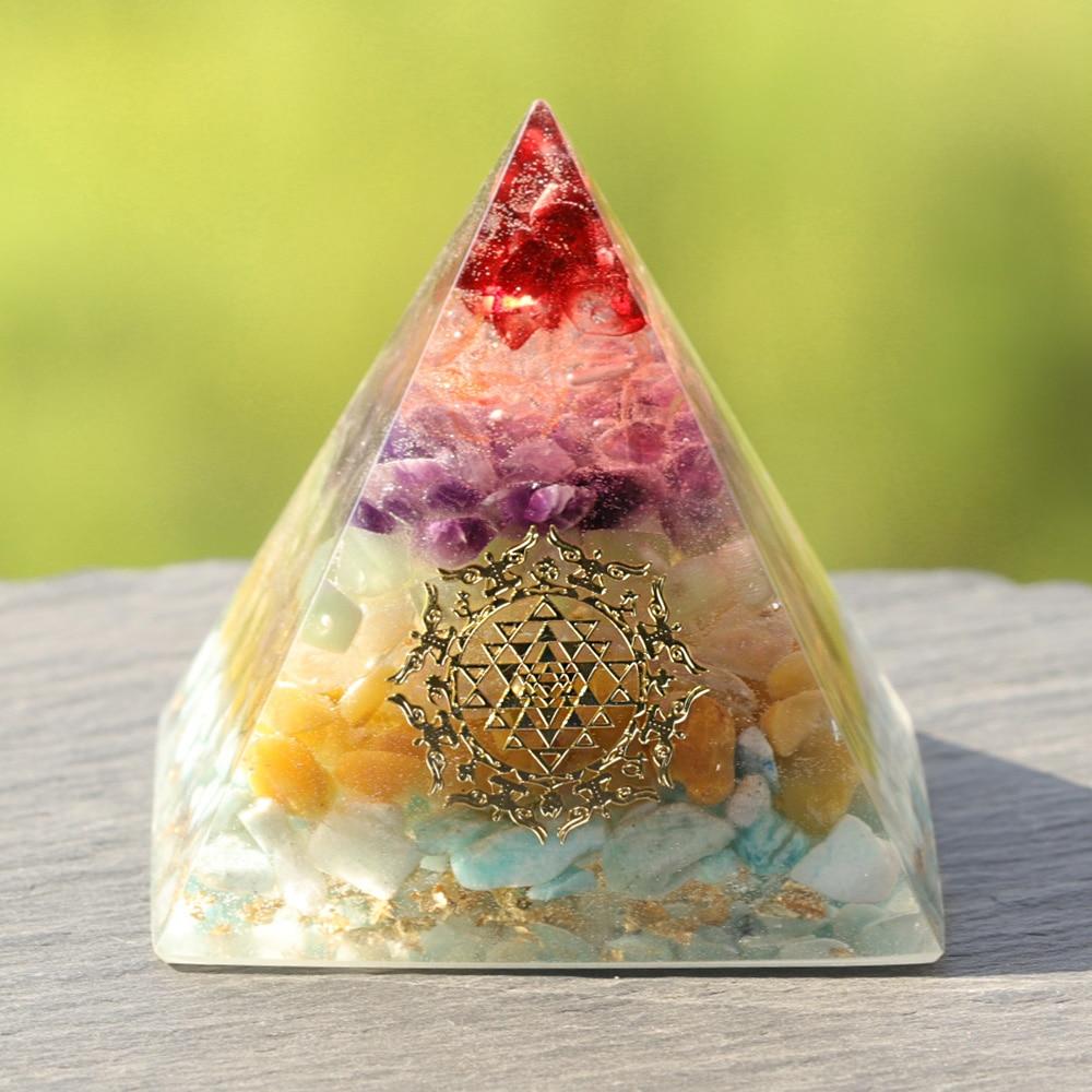 A beautifully crafted Orgonite Pyramid made from natural crystals including red agate, amethyst, and gold foil, featuring Metatron's Cube design.