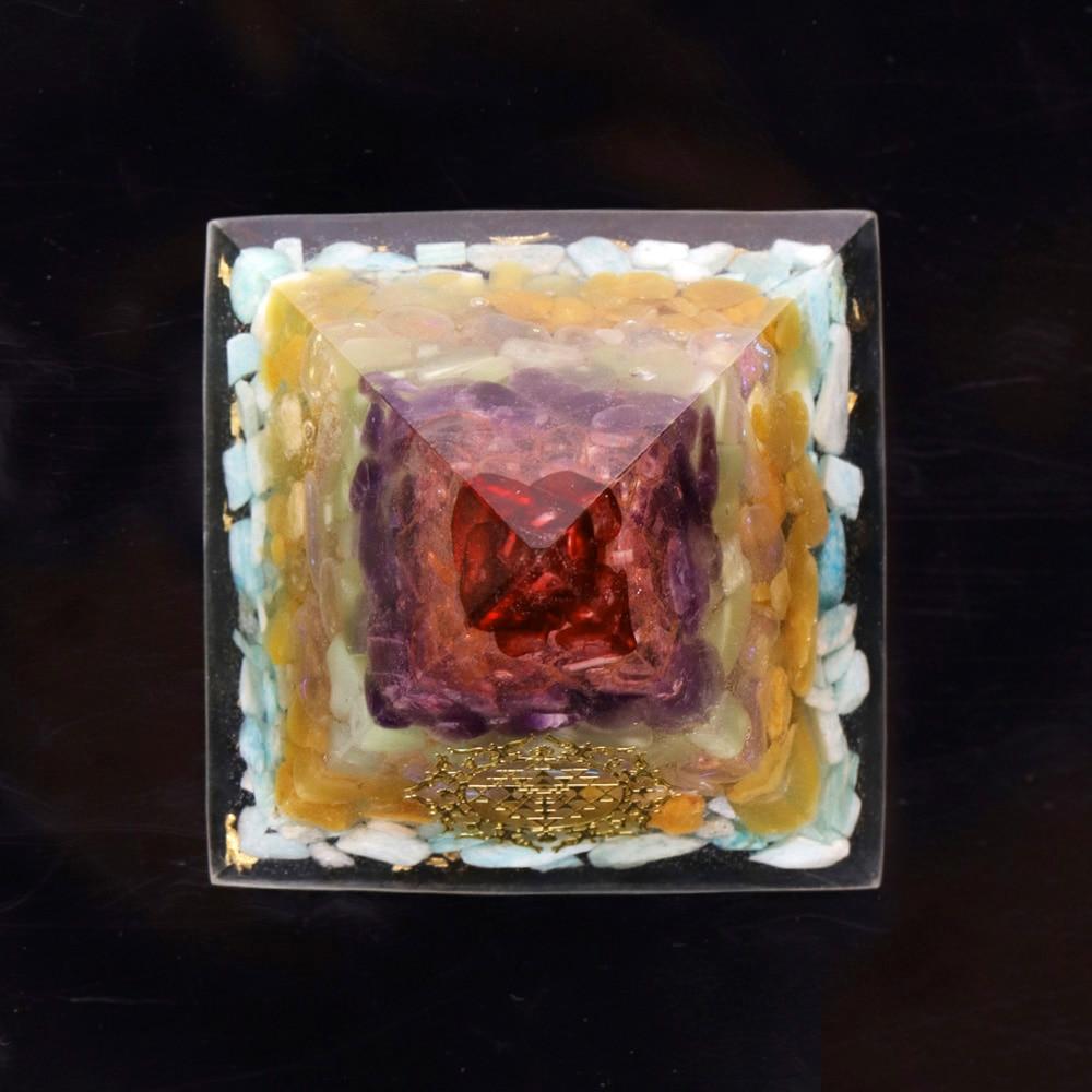 A beautifully crafted Orgonite Pyramid made from natural crystals including red agate, amethyst, and gold foil, featuring Metatron's Cube design.