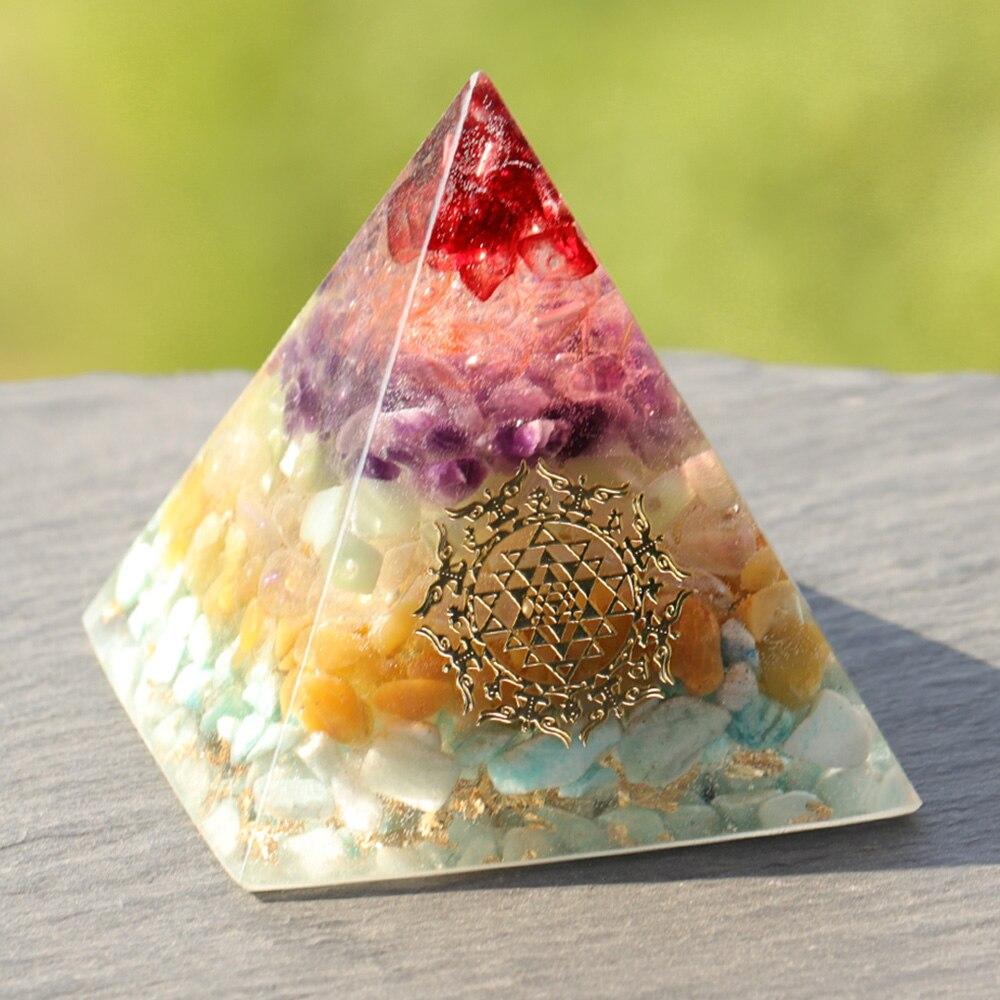 A beautifully crafted Orgonite Pyramid made from natural crystals including red agate, amethyst, and gold foil, featuring Metatron's Cube design.