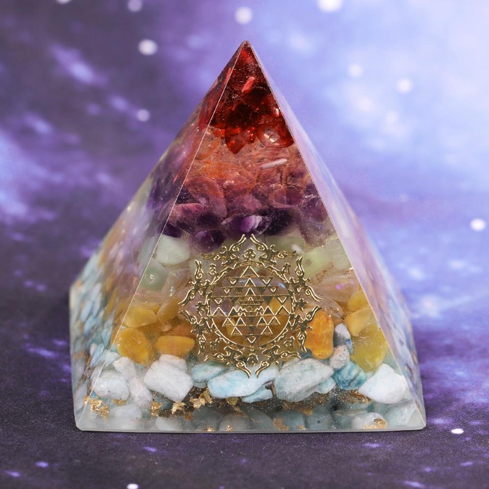 A beautifully crafted Orgonite Pyramid made from natural crystals including red agate, amethyst, and gold foil, featuring Metatron's Cube design.