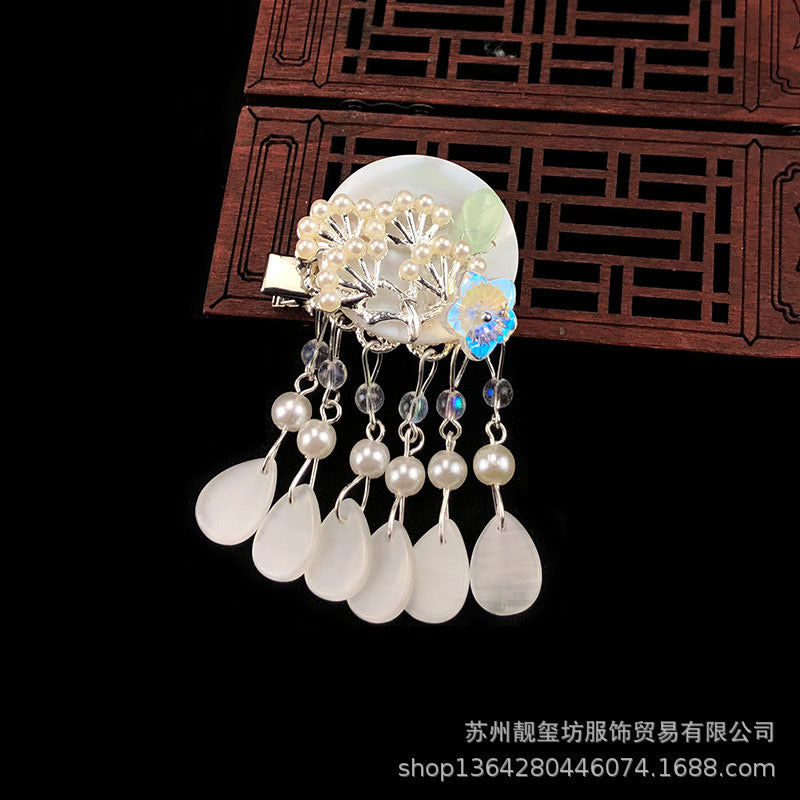 Elegant Oriental Shell Pearl Flower Hair Clip with tassels, showcasing intricate design and high-quality materials.