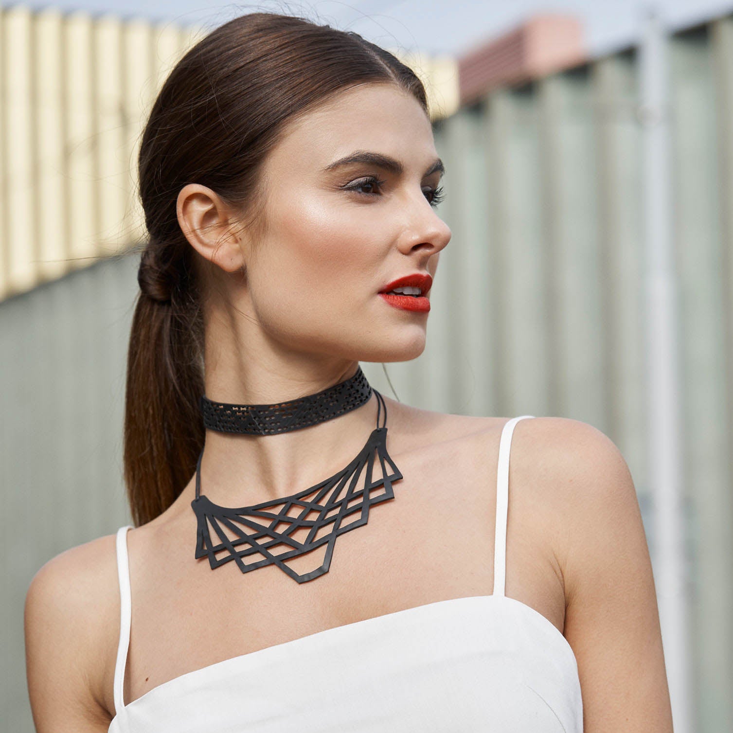 A stylish Origami Inner Tube Necklace made from recycled rubber, featuring a unique handcrafted design with a cotton cord.