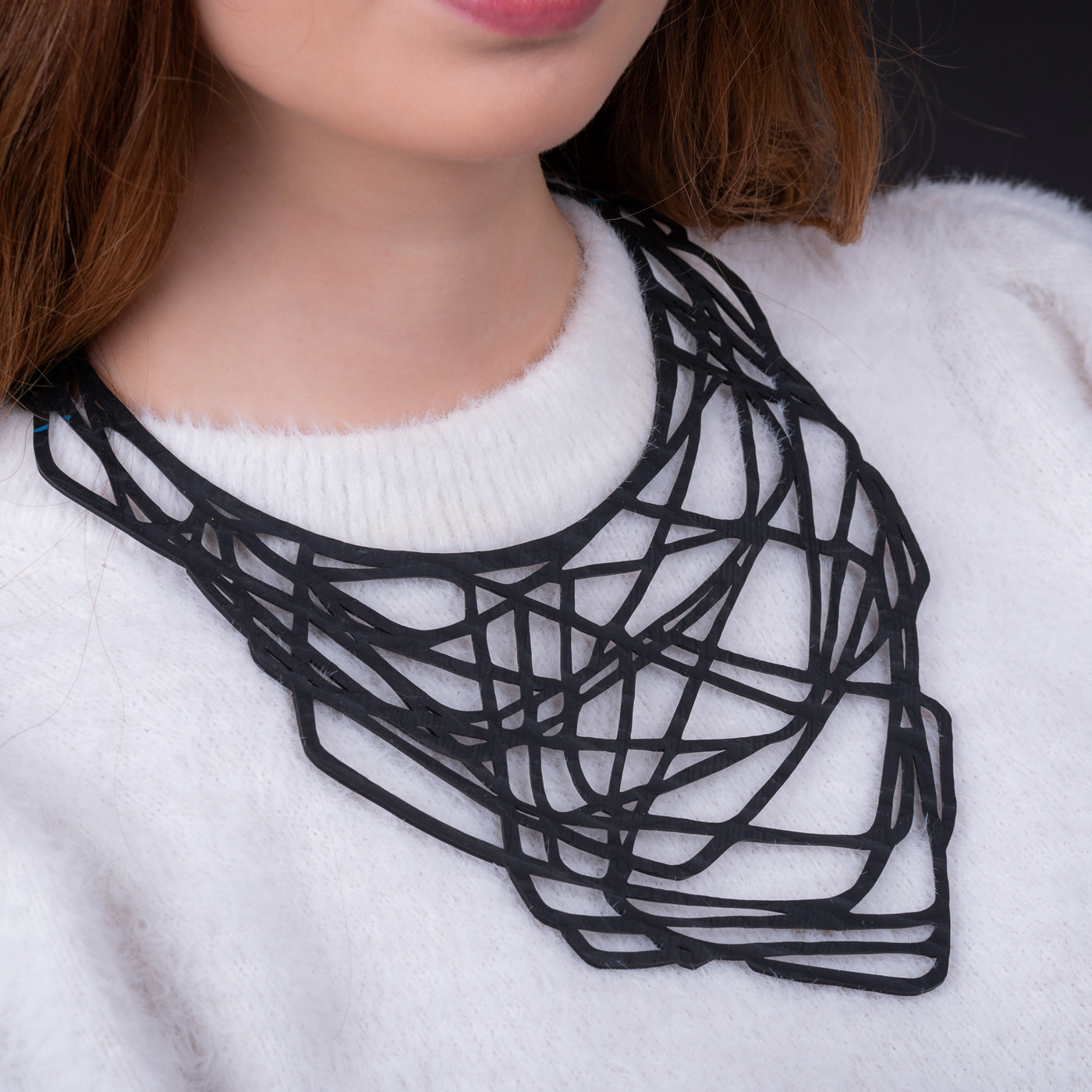 Orion Rubber Necklace made from upcycled inner tubes, featuring a geometric design and lightweight construction, displayed in a luxury gift box.