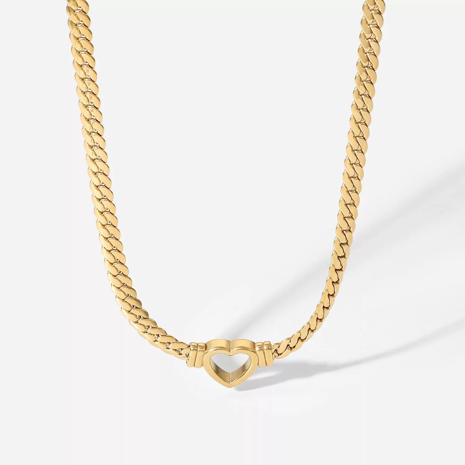 Oslo Heart Necklace featuring 18K gold plating, elegant heart design, perfect for casual or formal wear.