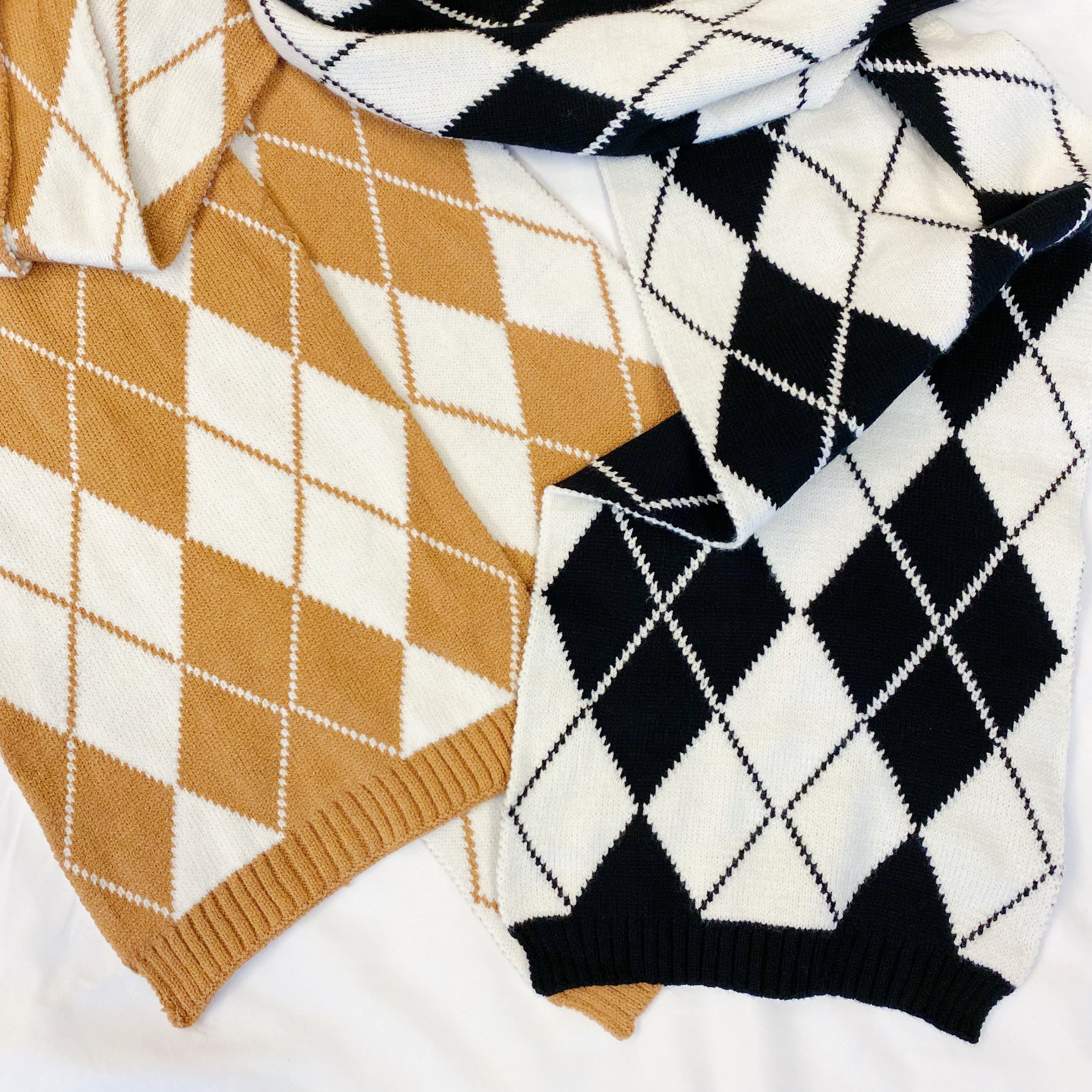 Cozy knit scarf featuring a classic argyle pattern, perfect for fall outfits, measuring 10 inches by 64 inches.