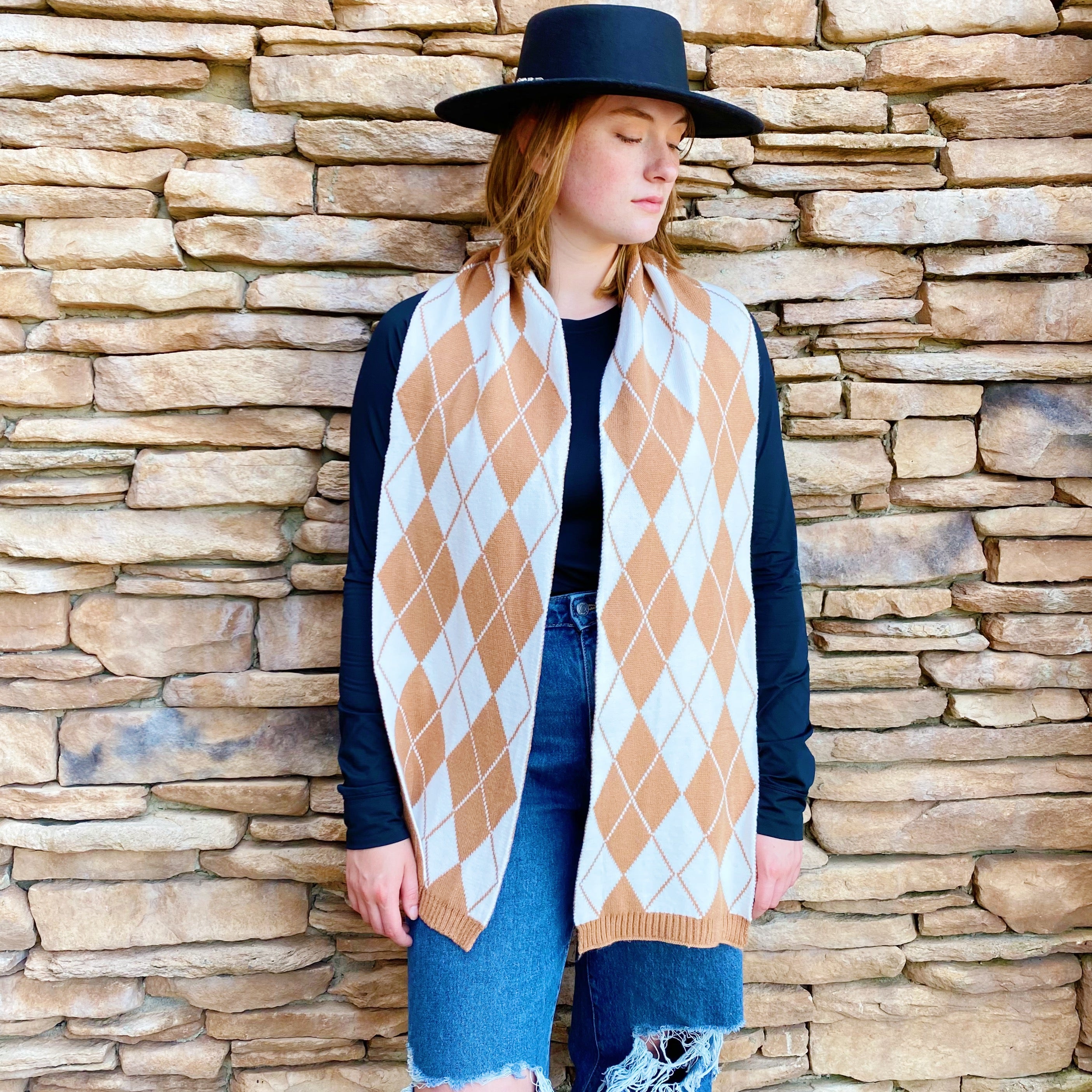 Cozy knit scarf featuring a classic argyle pattern, perfect for fall outfits, measuring 10 inches by 64 inches.