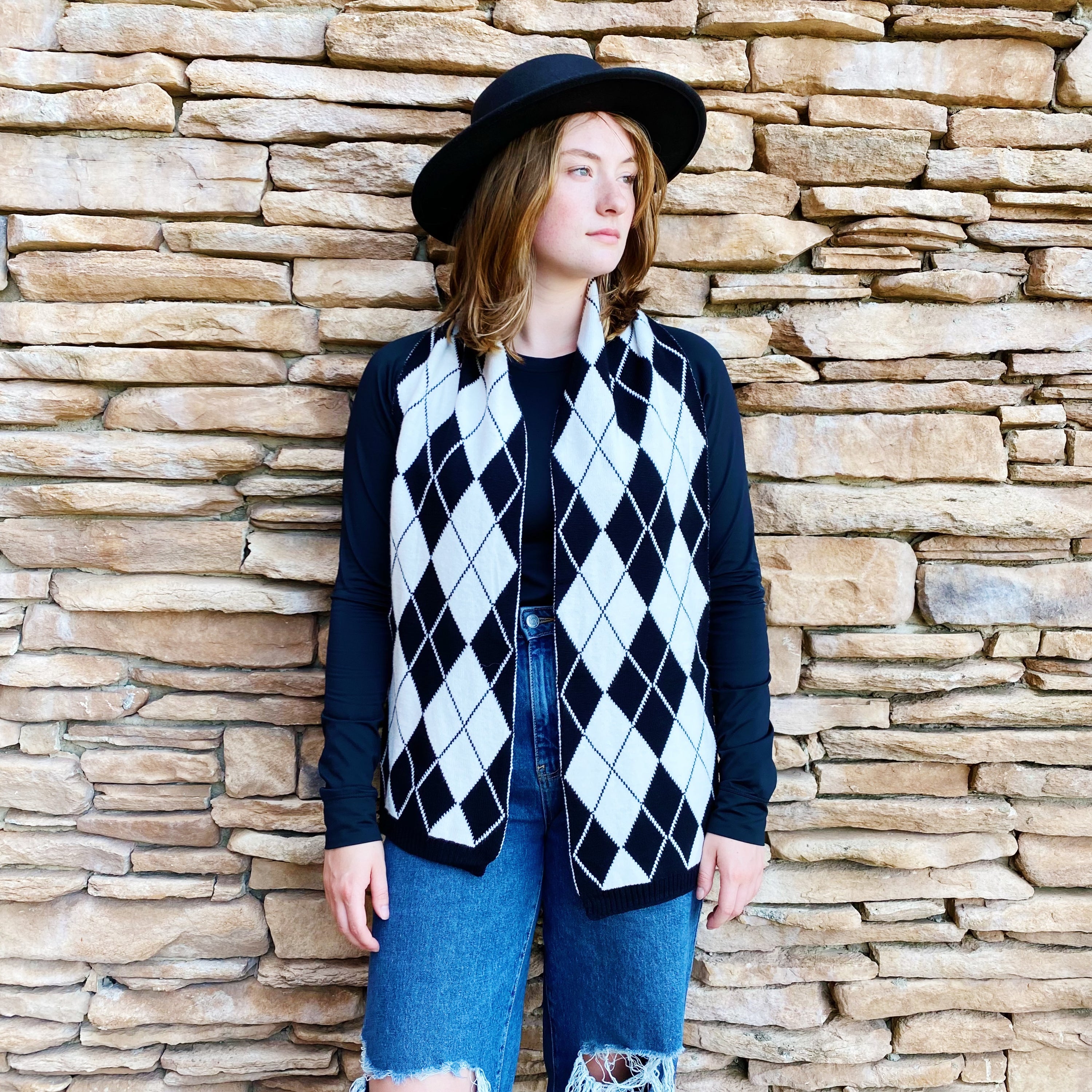 Cozy knit scarf featuring a classic argyle pattern, perfect for fall outfits, measuring 10 inches by 64 inches.