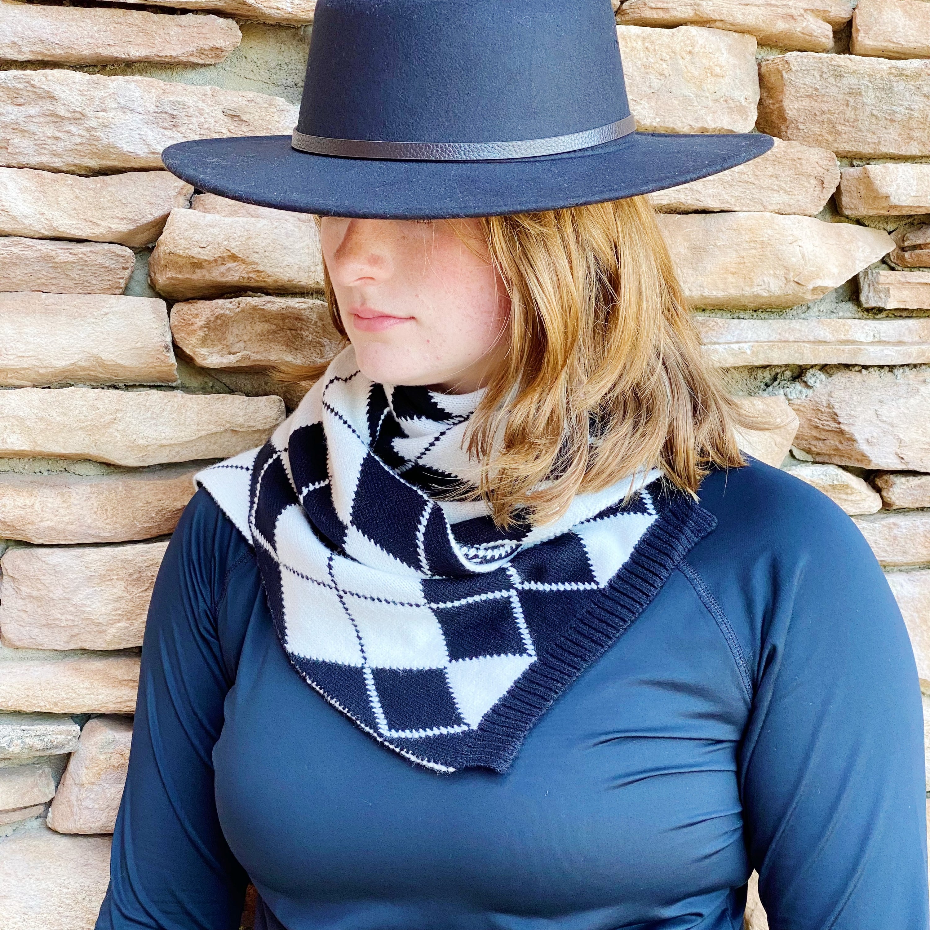 Cozy knit scarf featuring a classic argyle pattern, perfect for fall outfits, measuring 10 inches by 64 inches.