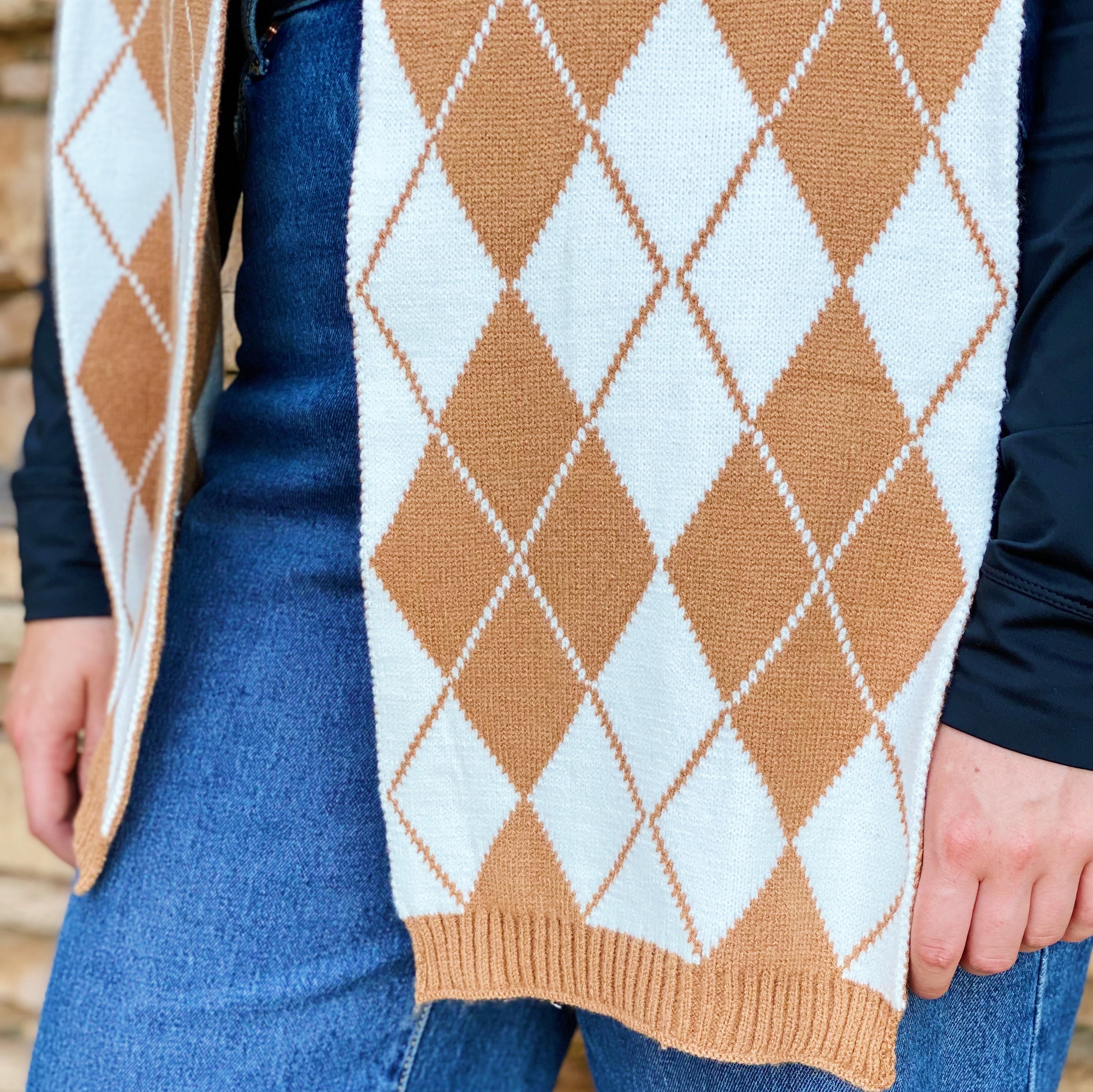 Cozy knit scarf featuring a classic argyle pattern, perfect for fall outfits, measuring 10 inches by 64 inches.