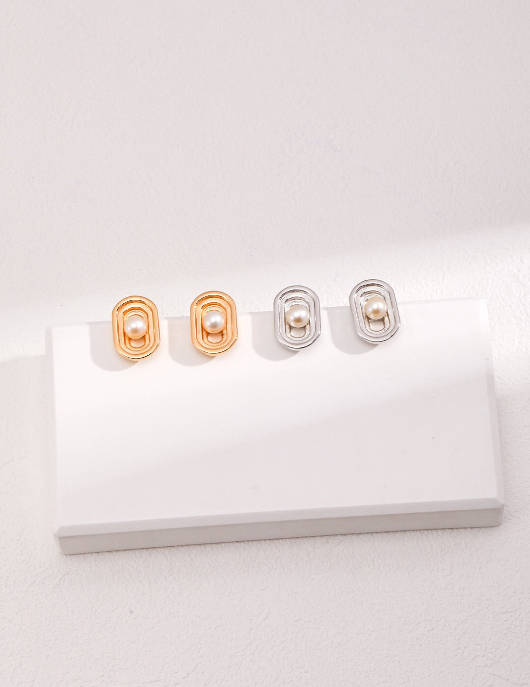 Elegant Oval Hollow Pearl Stud Earrings made from natural pearls and gold vermeil, showcasing a modern design.