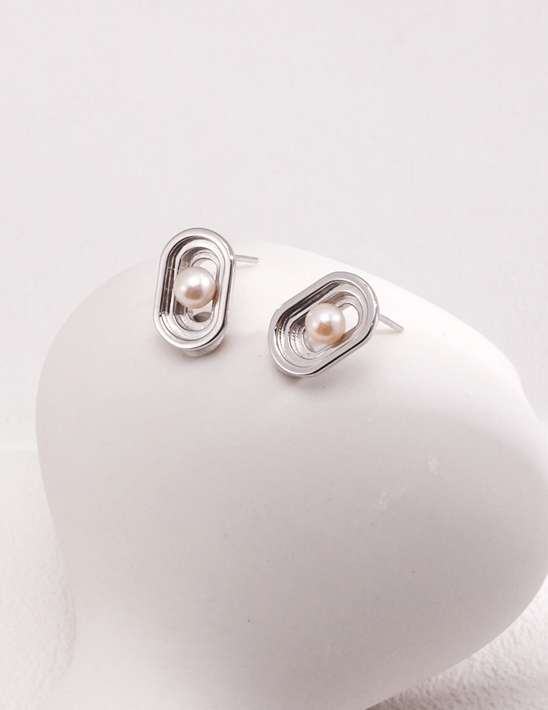 Elegant Oval Hollow Pearl Stud Earrings made from natural pearls and gold vermeil, showcasing a modern design.