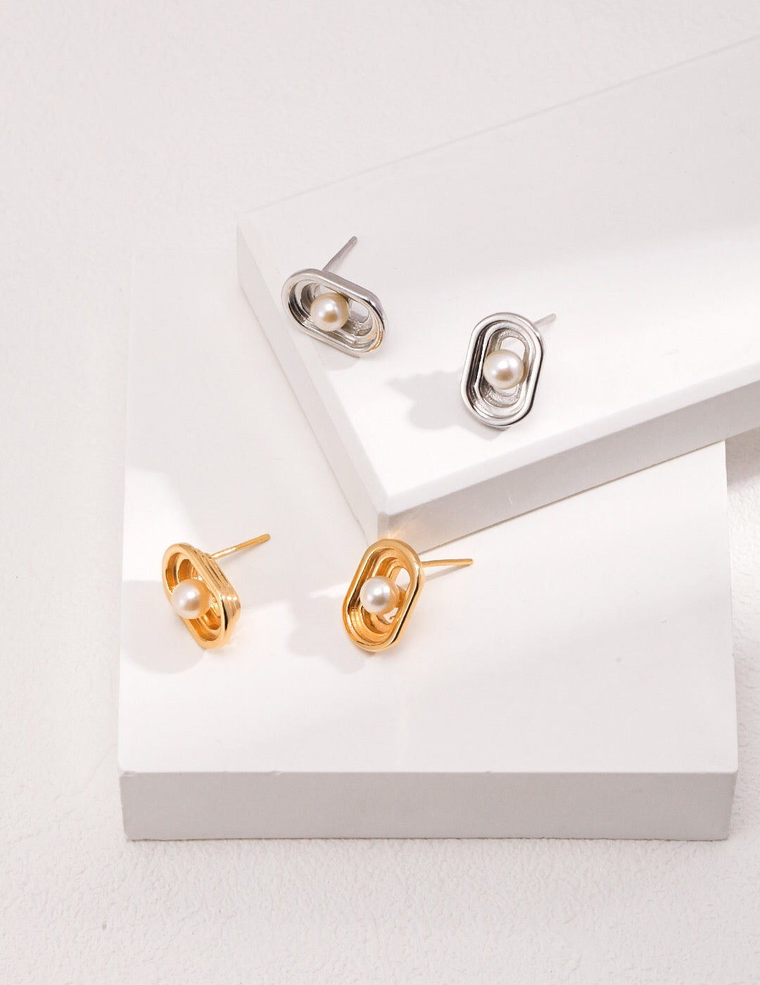 Elegant Oval Hollow Pearl Stud Earrings made from natural pearls and gold vermeil, showcasing a modern design.