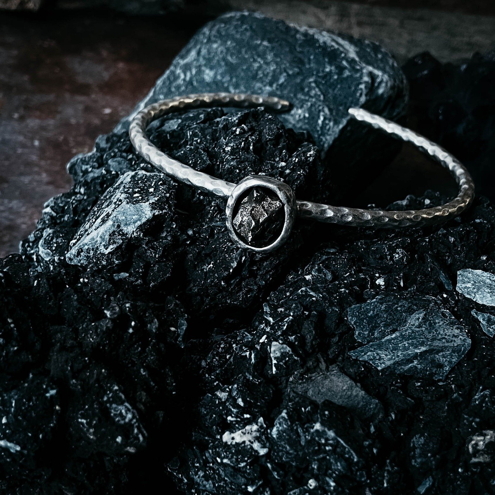 Oval Meteorite Cuff Bracelet featuring a raw Campo del Cielo meteorite set in a textured silver-tone cuff.