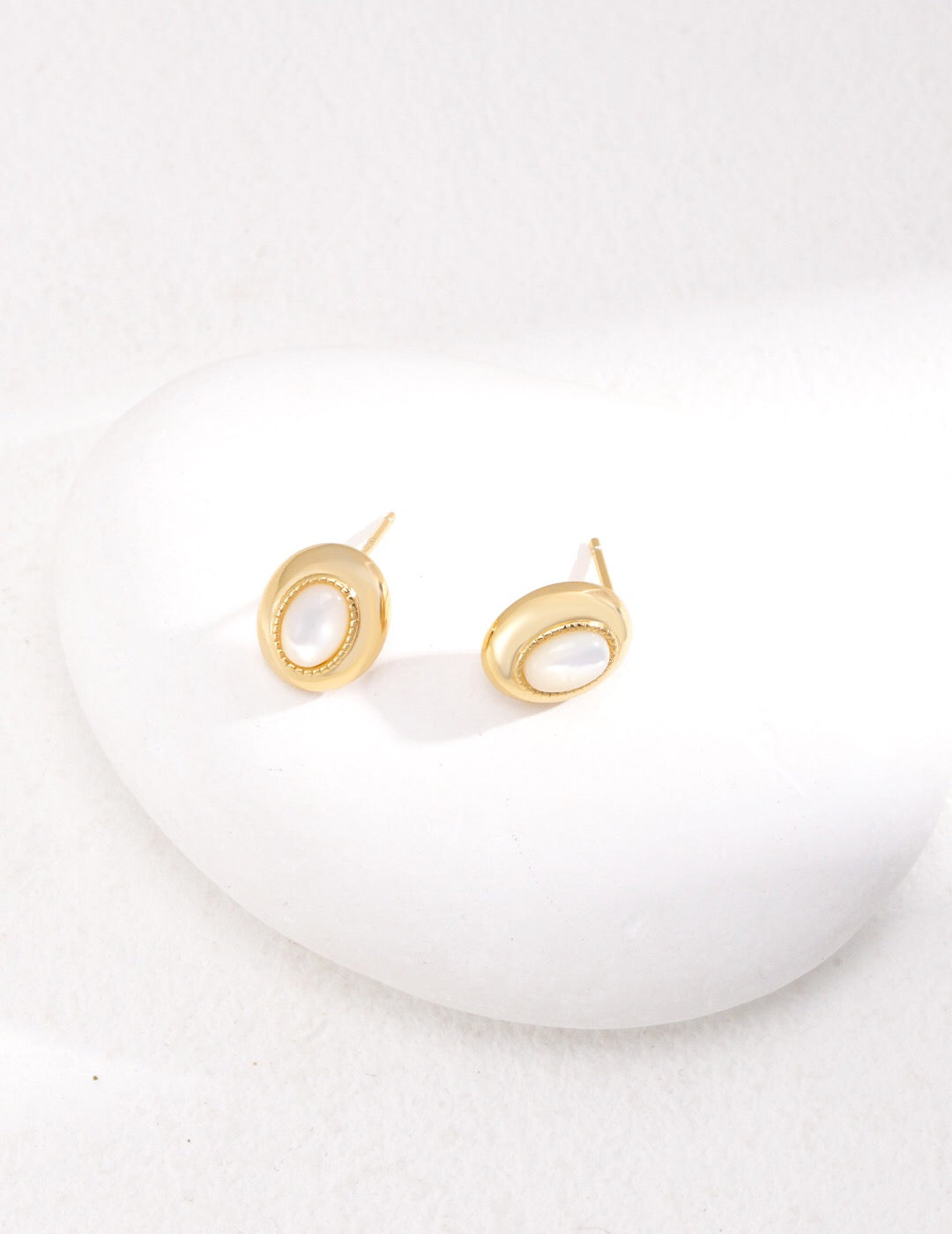 Elegant Oval Mother of Pearl Earrings with gold vermeil finish, showcasing their iridescent sheen and handcrafted design.