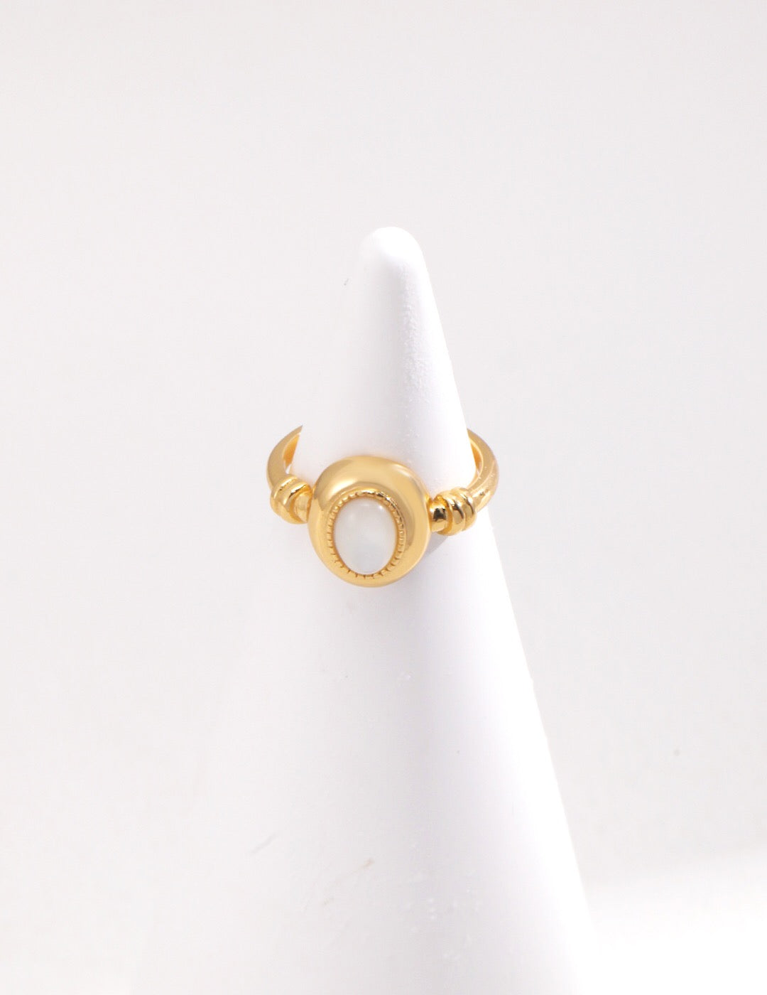 A stunning Oval Mother Of Pearl Ring featuring a gold vermeil setting, showcasing its elegant design and craftsmanship.