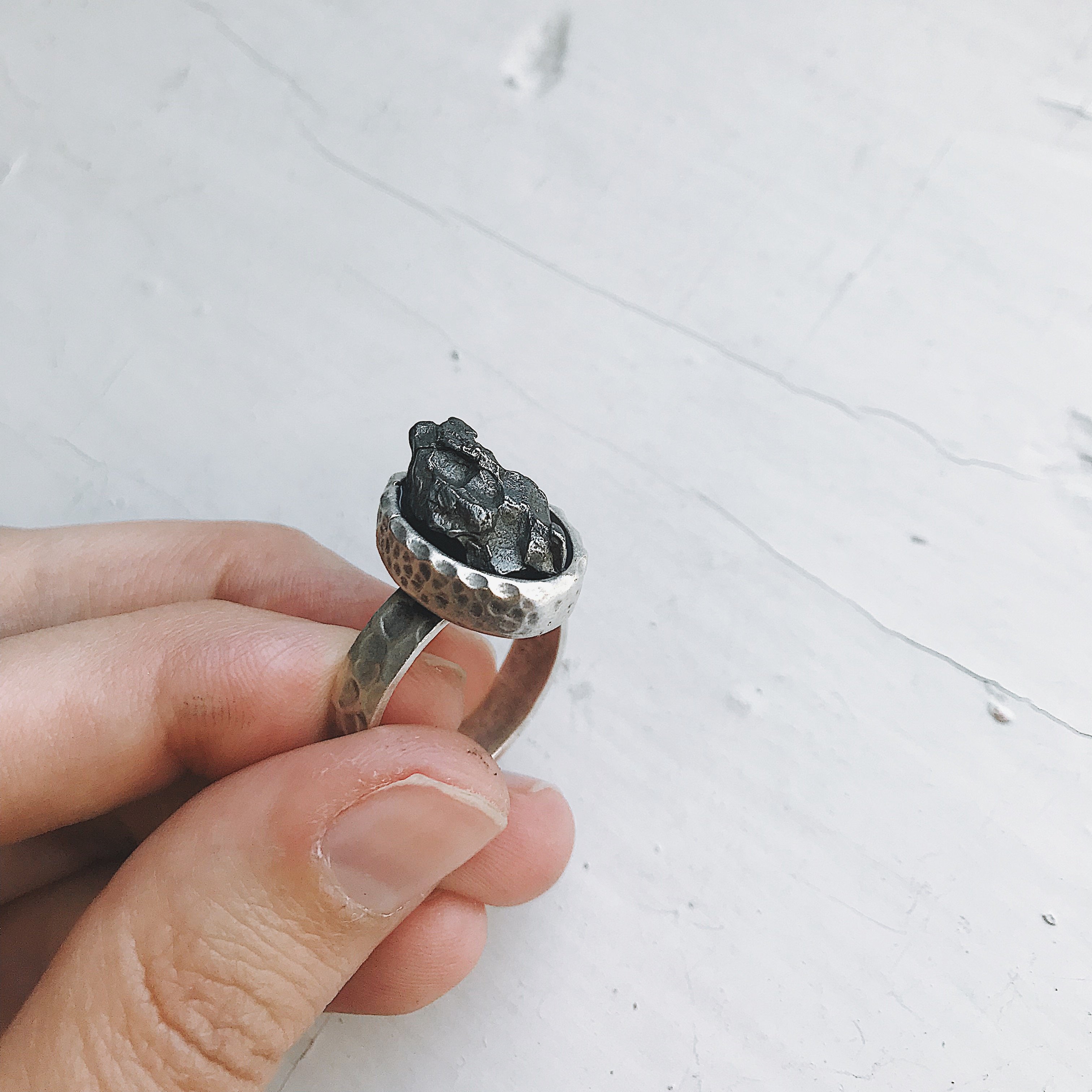 Oval Raw Meteorite Ring in Silver with a thick hammered bezel, showcasing a unique piece of authentic meteorite.