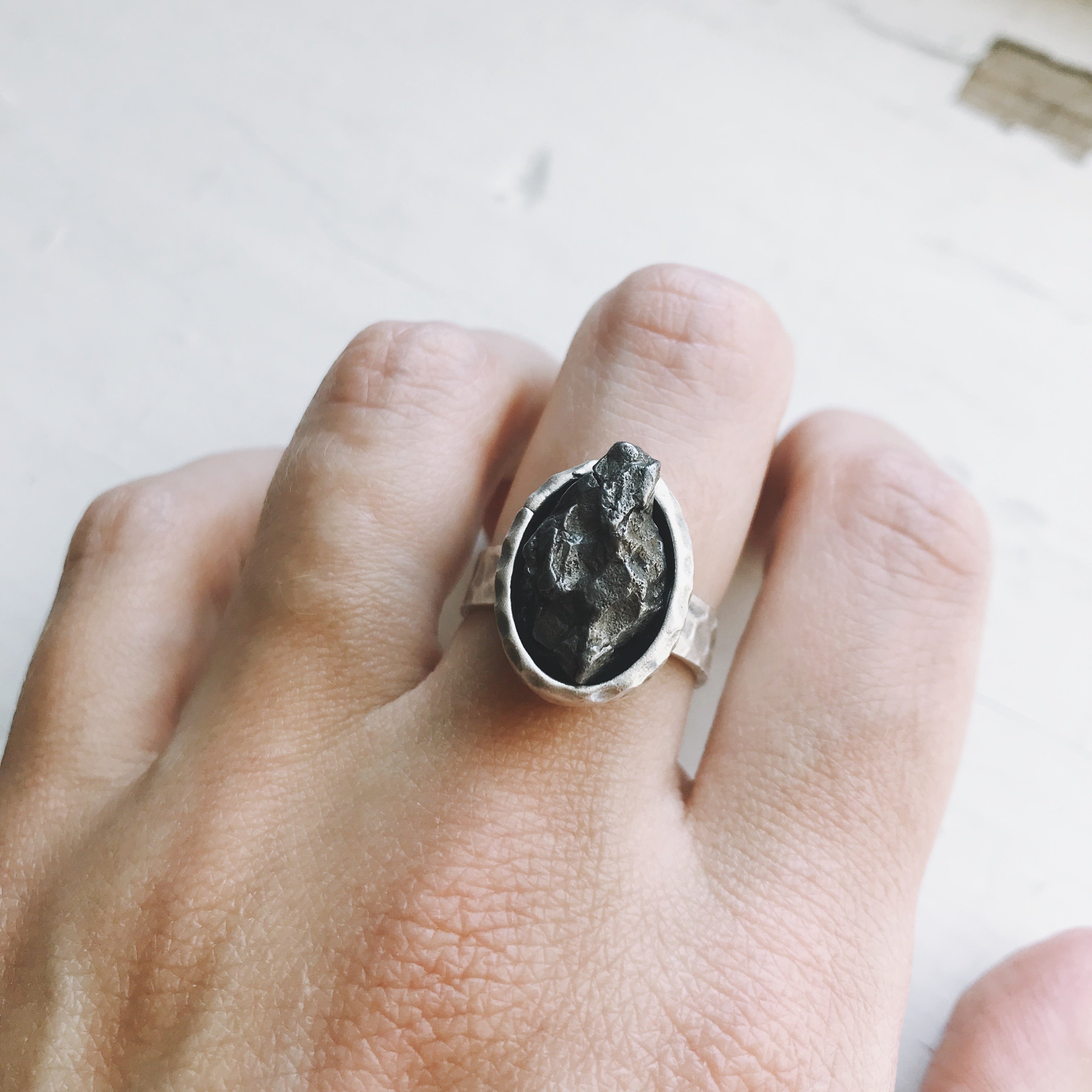 Oval Raw Meteorite Ring in Silver with a thick hammered bezel, showcasing a unique piece of authentic meteorite.