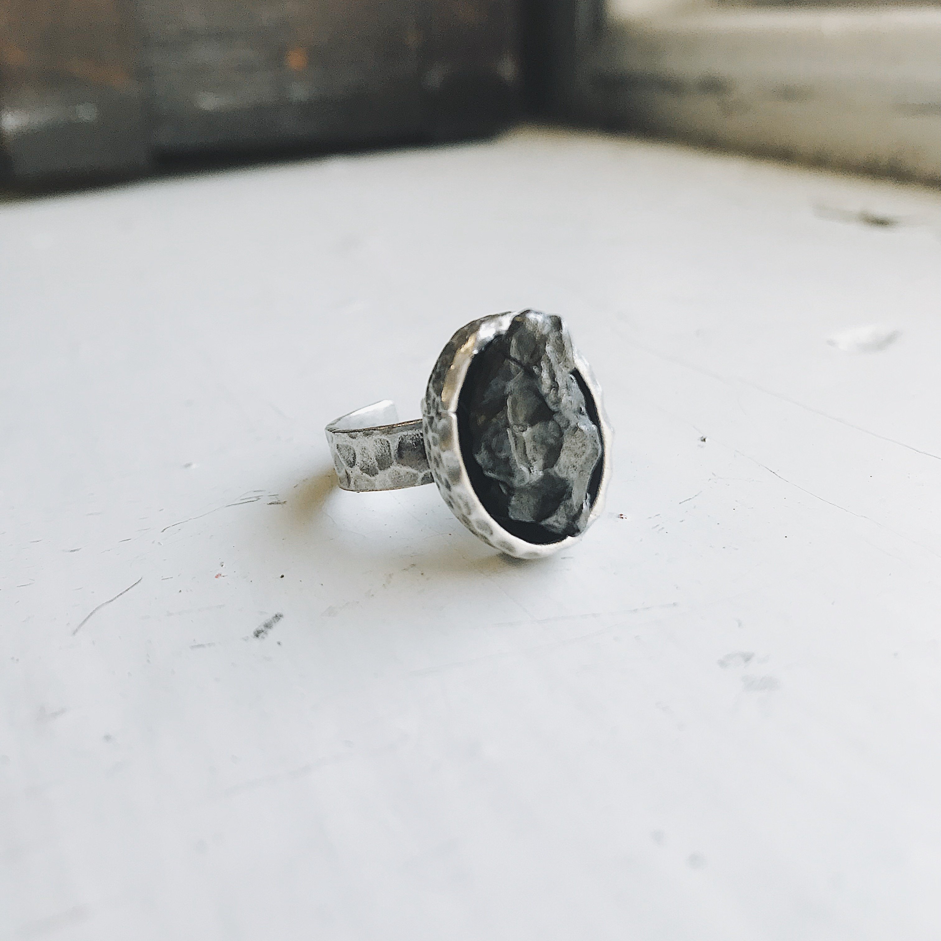 Oval Raw Meteorite Ring in Silver with a thick hammered bezel, showcasing a unique piece of authentic meteorite.