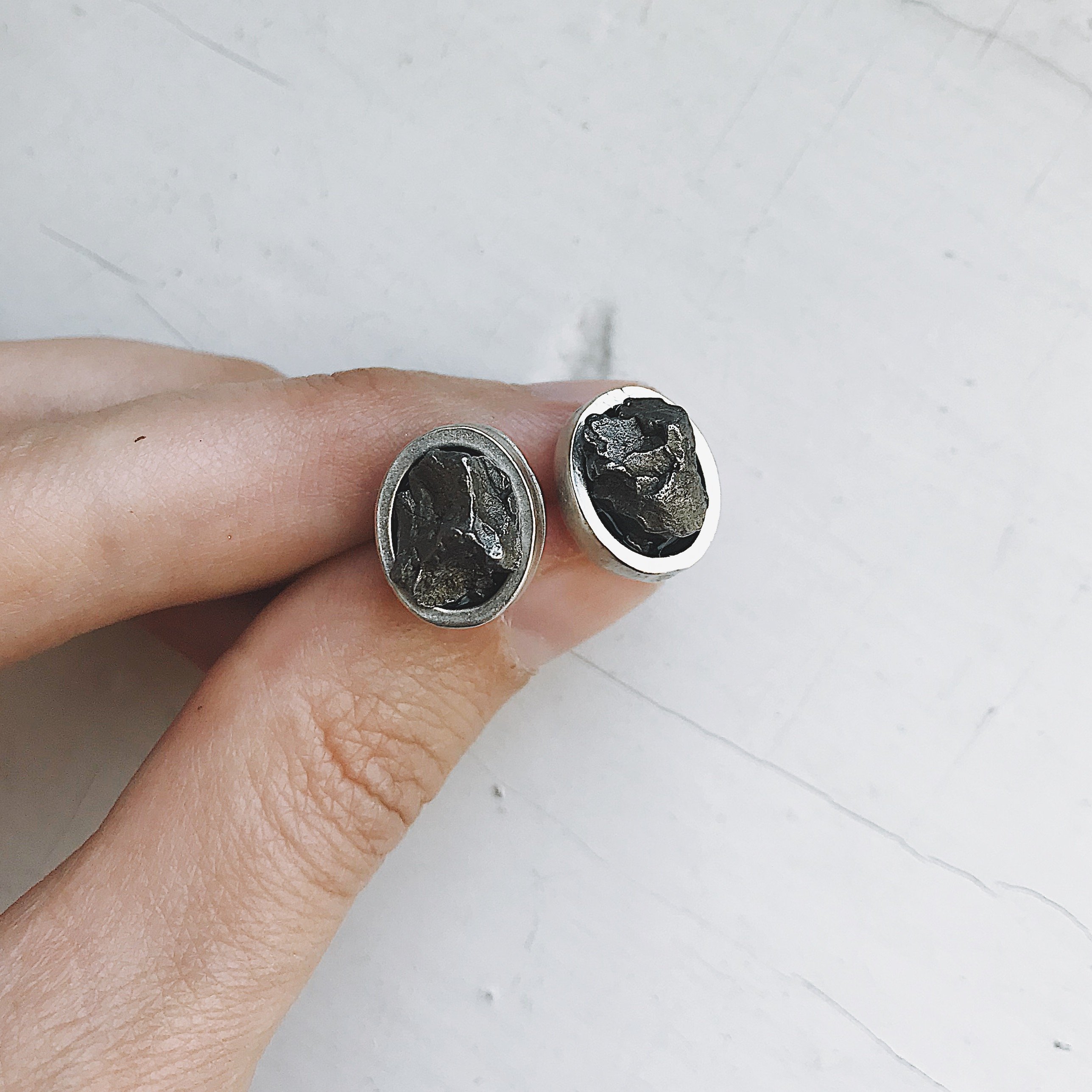 Oval Raw Meteorite Small Stud Earrings set in thick silver bezels, showcasing unique cosmic stones.