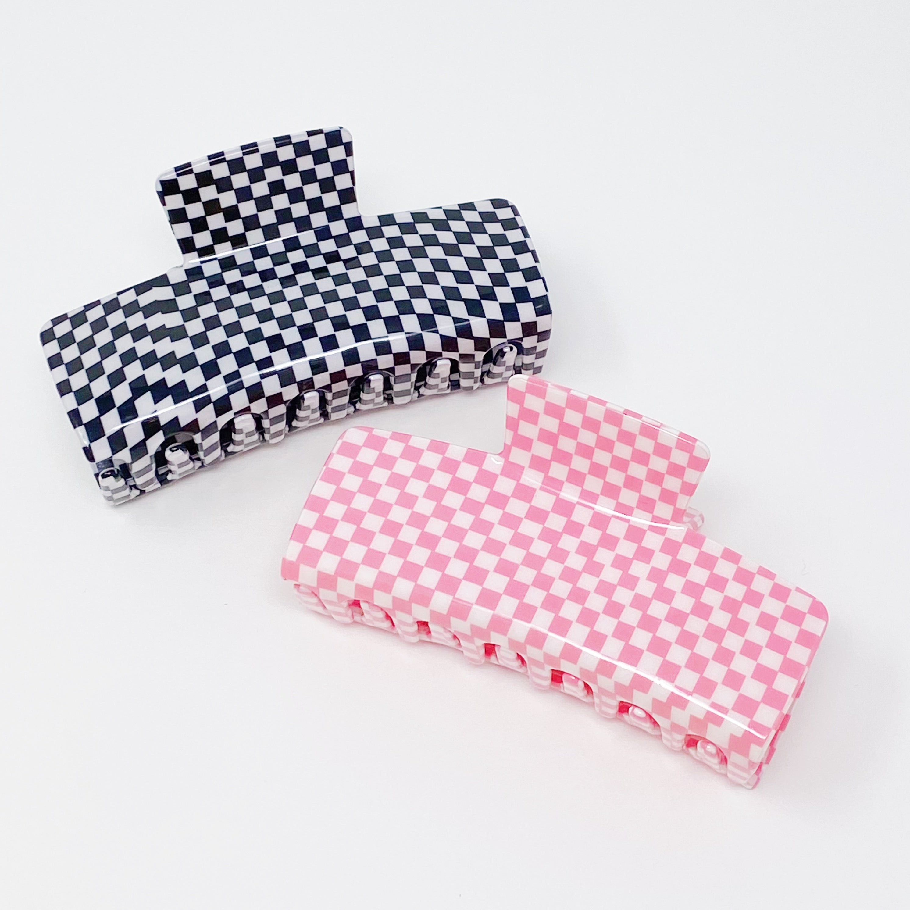 Oversized checkered hair claw clip in black and white pattern, designed for thick hair, measuring 4 inches by 2 inches.