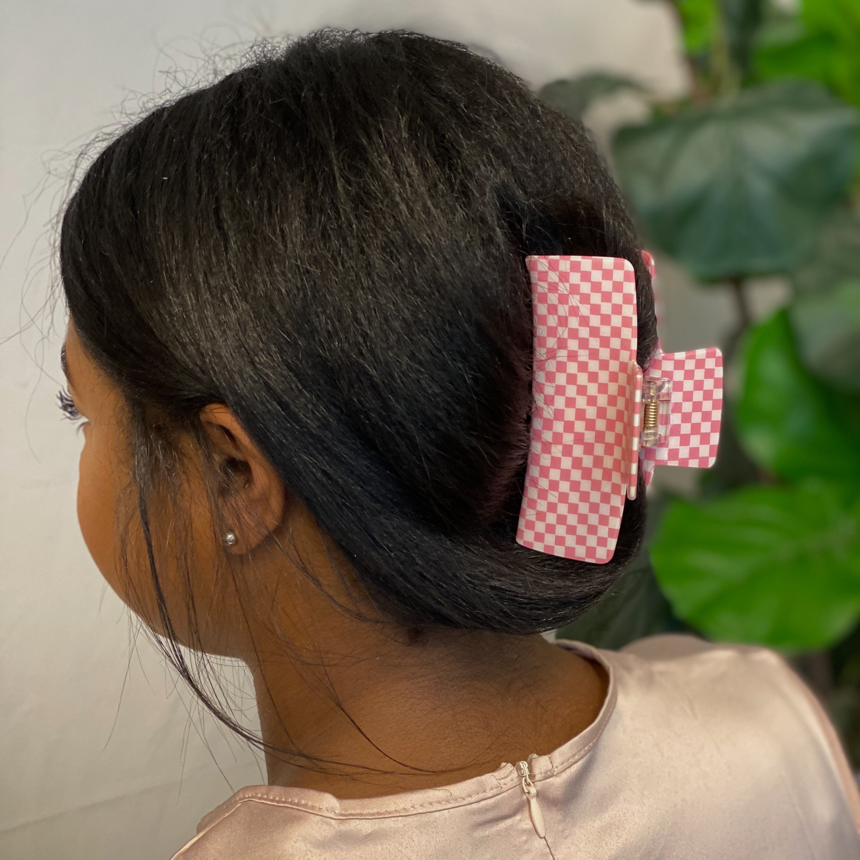 Oversized checkered hair claw clip in black and white pattern, designed for thick hair, measuring 4 inches by 2 inches.