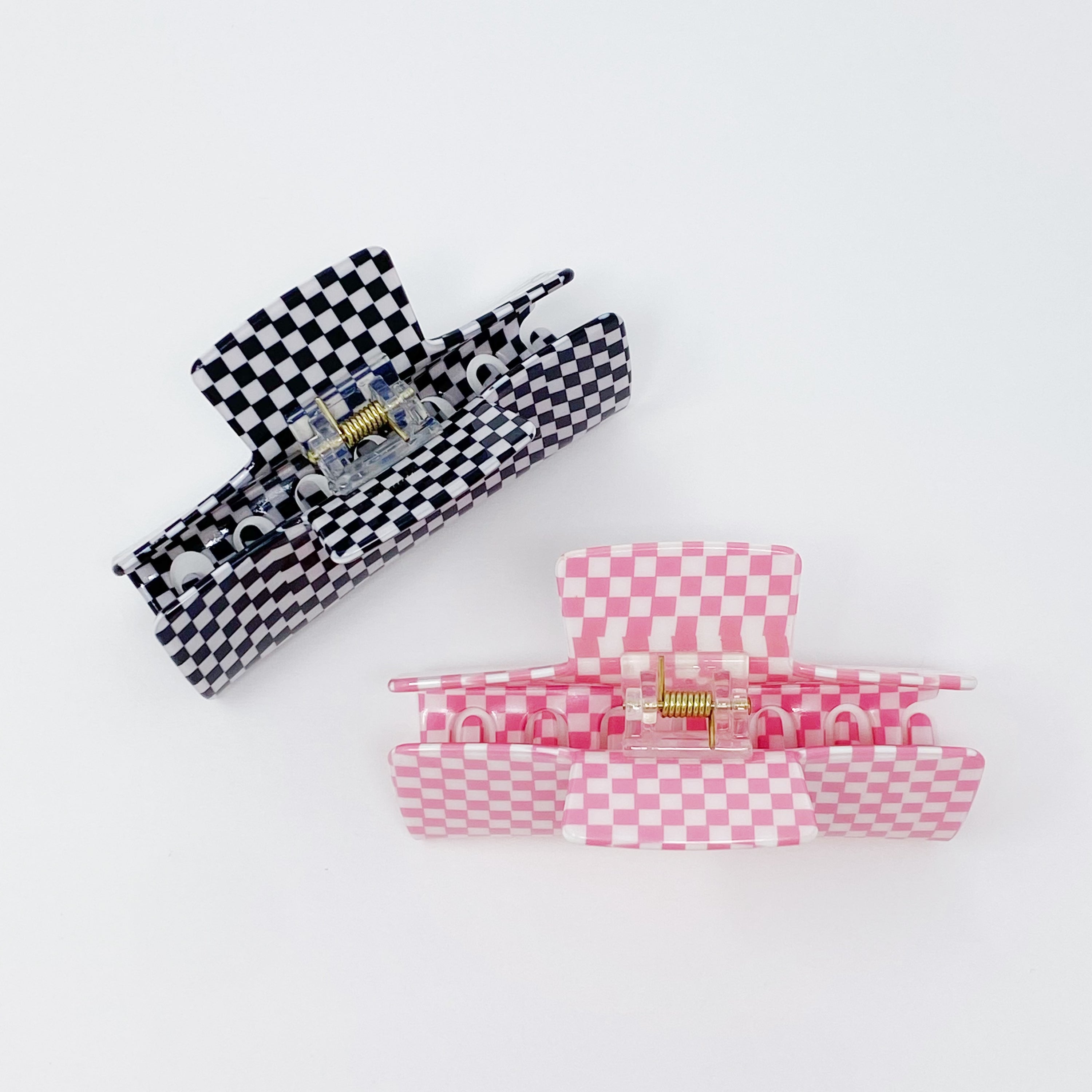 Oversized checkered hair claw clip in black and white pattern, designed for thick hair, measuring 4 inches by 2 inches.