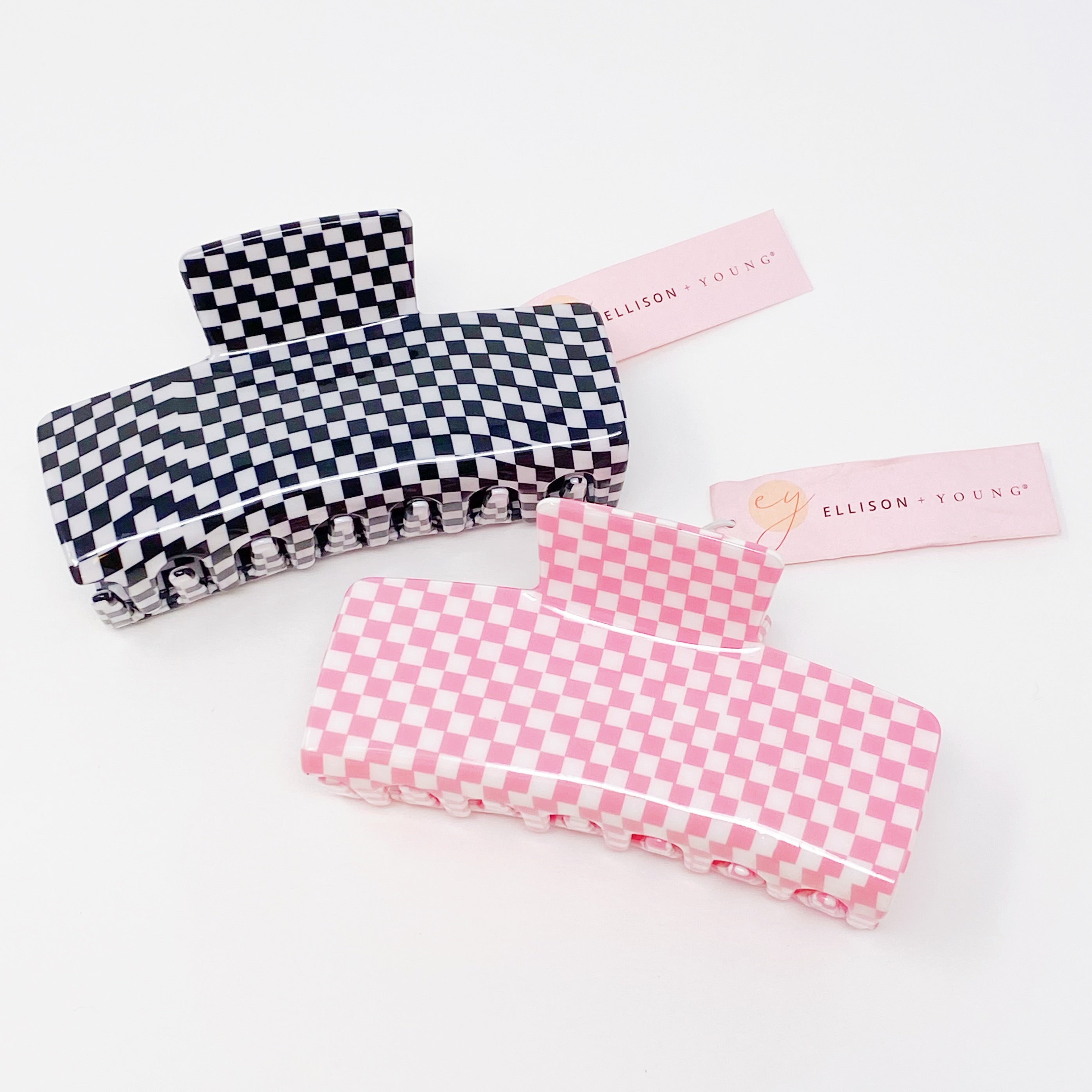 Oversized checkered hair claw clip in black and white pattern, designed for thick hair, measuring 4 inches by 2 inches.