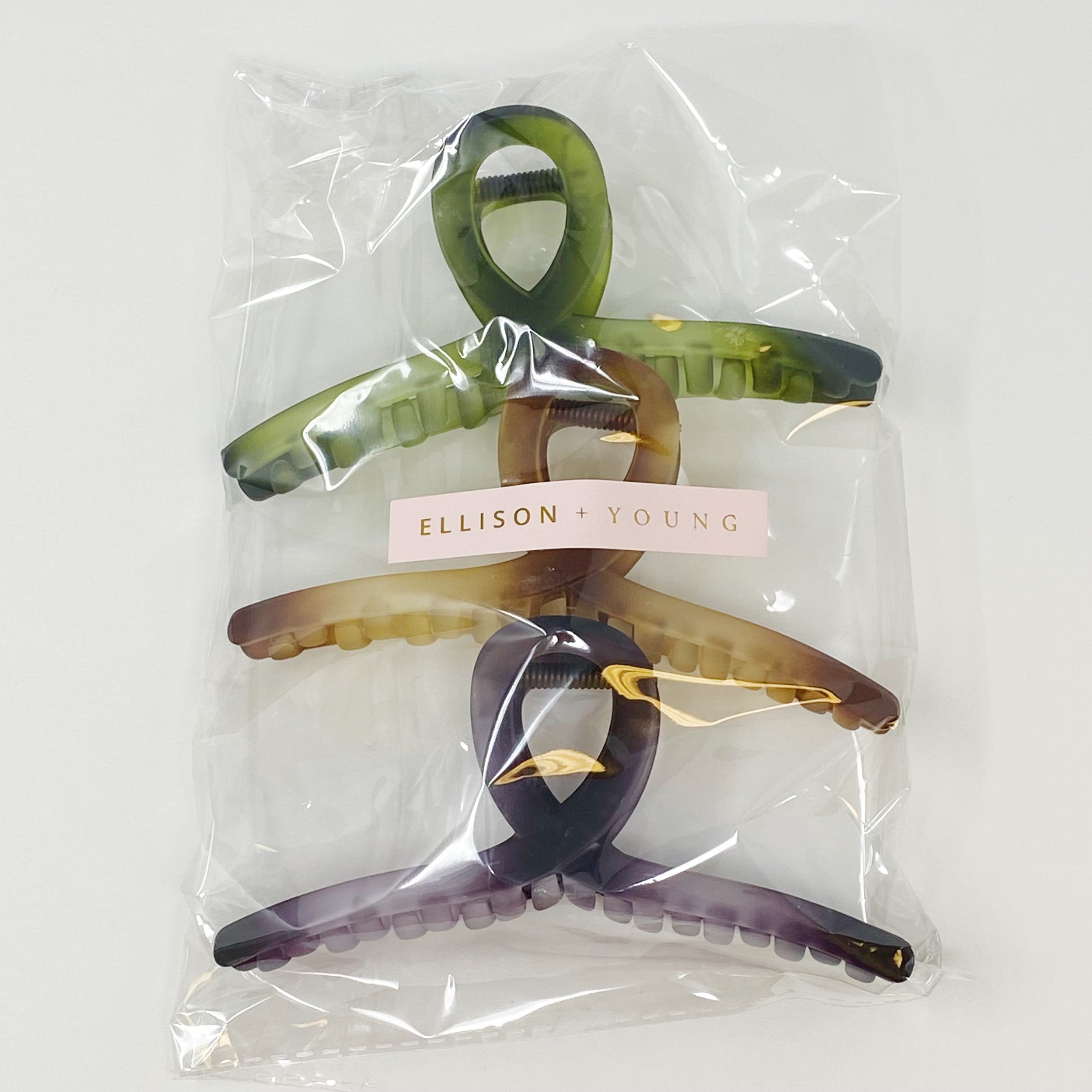 Set of three oversized hair claws in mystic ombre colors, elegantly displayed in a clear cello bag.