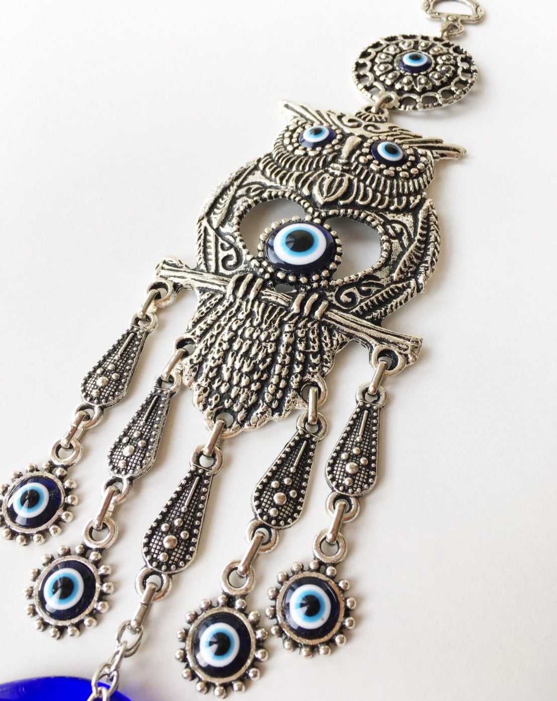 Handmade Owl Evil Eye Wall Hanging featuring a vibrant evil eye bead and an intricately designed owl figure, symbolizing protection and good luck.