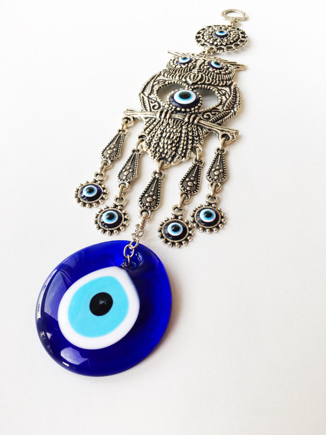 Handmade Owl Evil Eye Wall Hanging featuring a vibrant evil eye bead and an intricately designed owl figure, symbolizing protection and good luck.