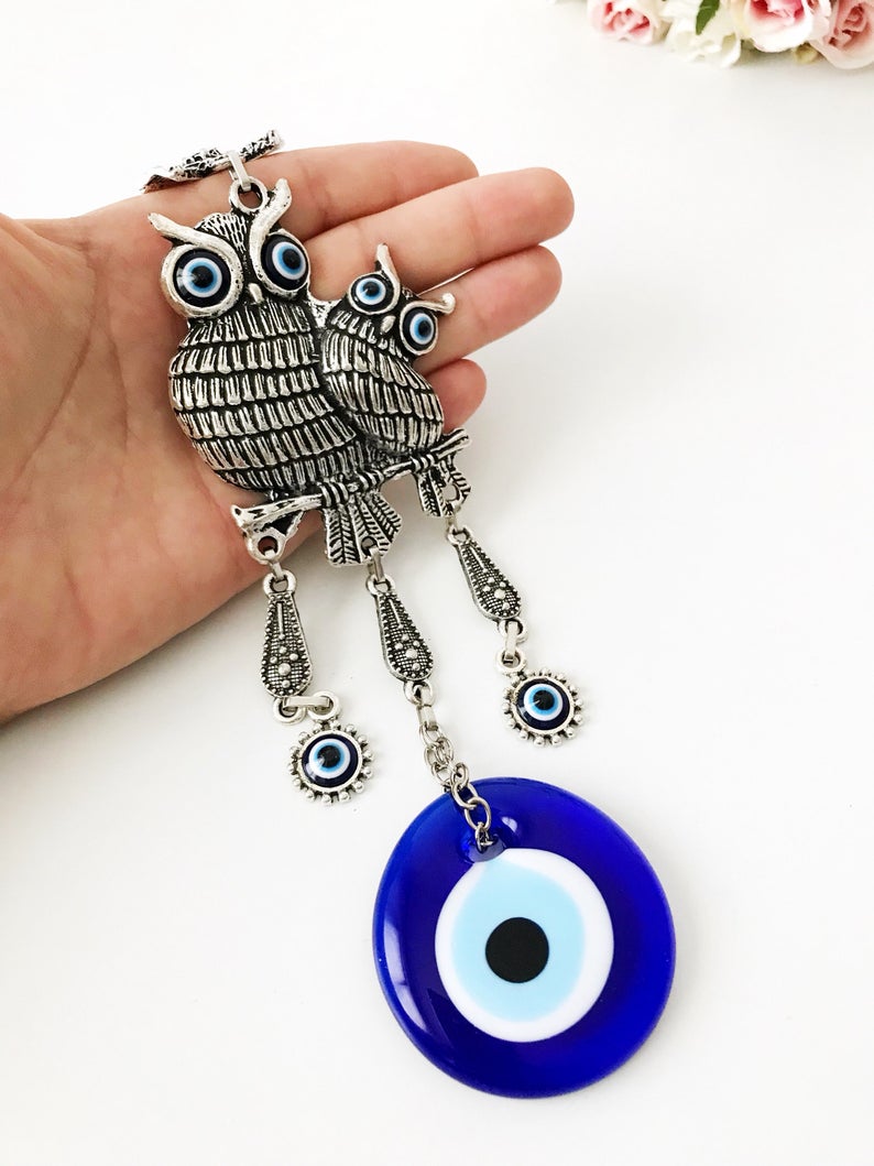 Handmade Owl Evil Eye Wall Hanging featuring a blue evil eye charm and intricate metal design, perfect for home decor.