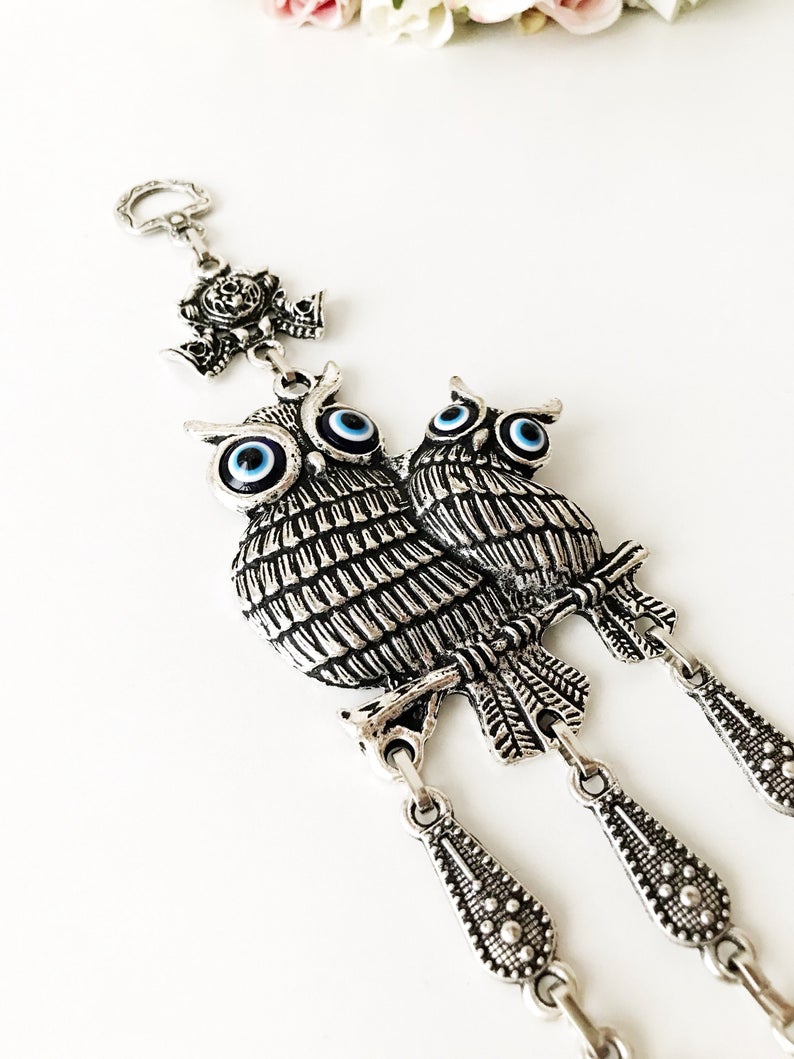 Handmade Owl Evil Eye Wall Hanging featuring a blue evil eye charm and intricate metal design, perfect for home decor.