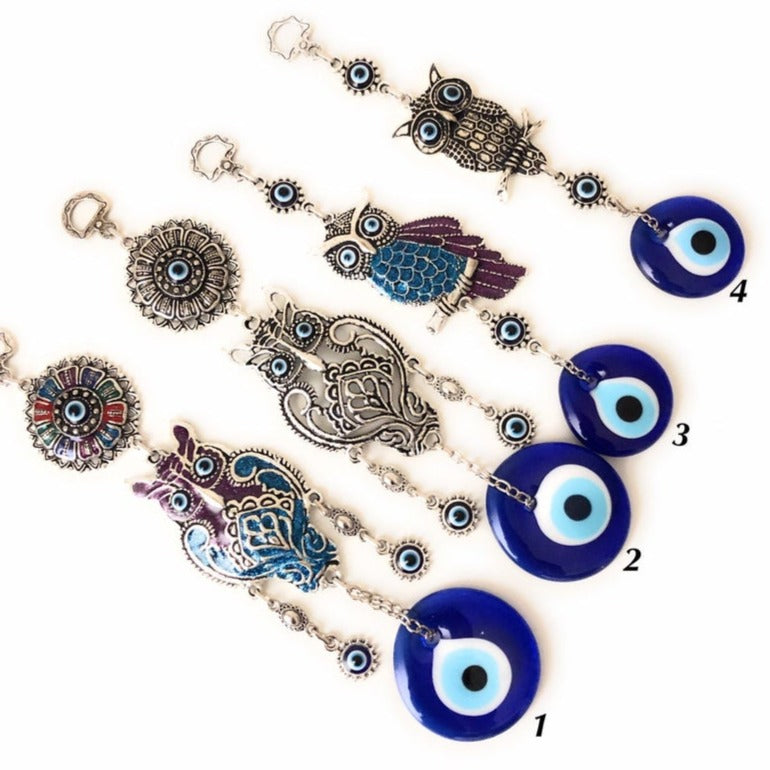 A beautifully crafted owl wall hanging featuring vibrant glass evil eyes, symbolizing protection and good luck, perfect for home decoration.