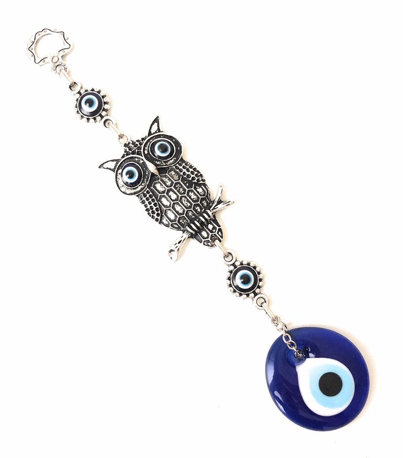 A beautifully crafted owl wall hanging featuring vibrant glass evil eyes, symbolizing protection and good luck, perfect for home decoration.