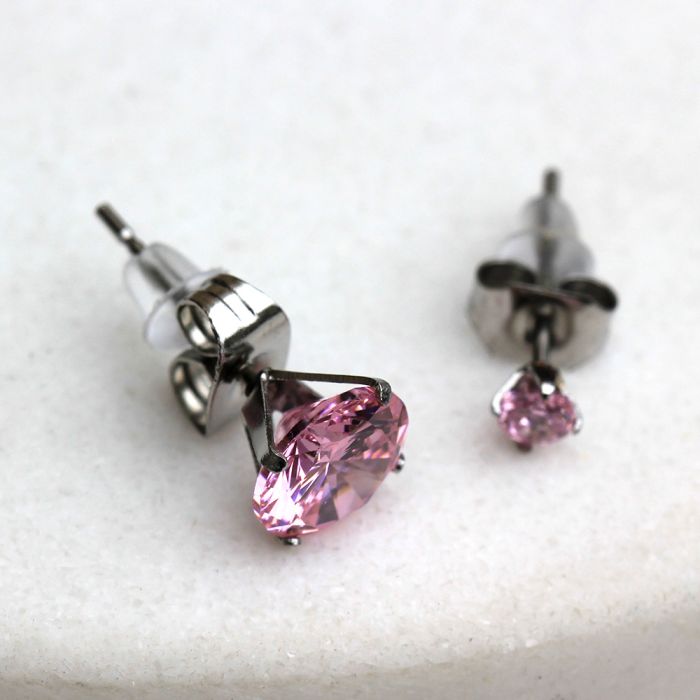 A pair of elegant 316L surgical steel pink round cubic zirconia stud earrings, showcasing their sparkling stones and secure clutches.