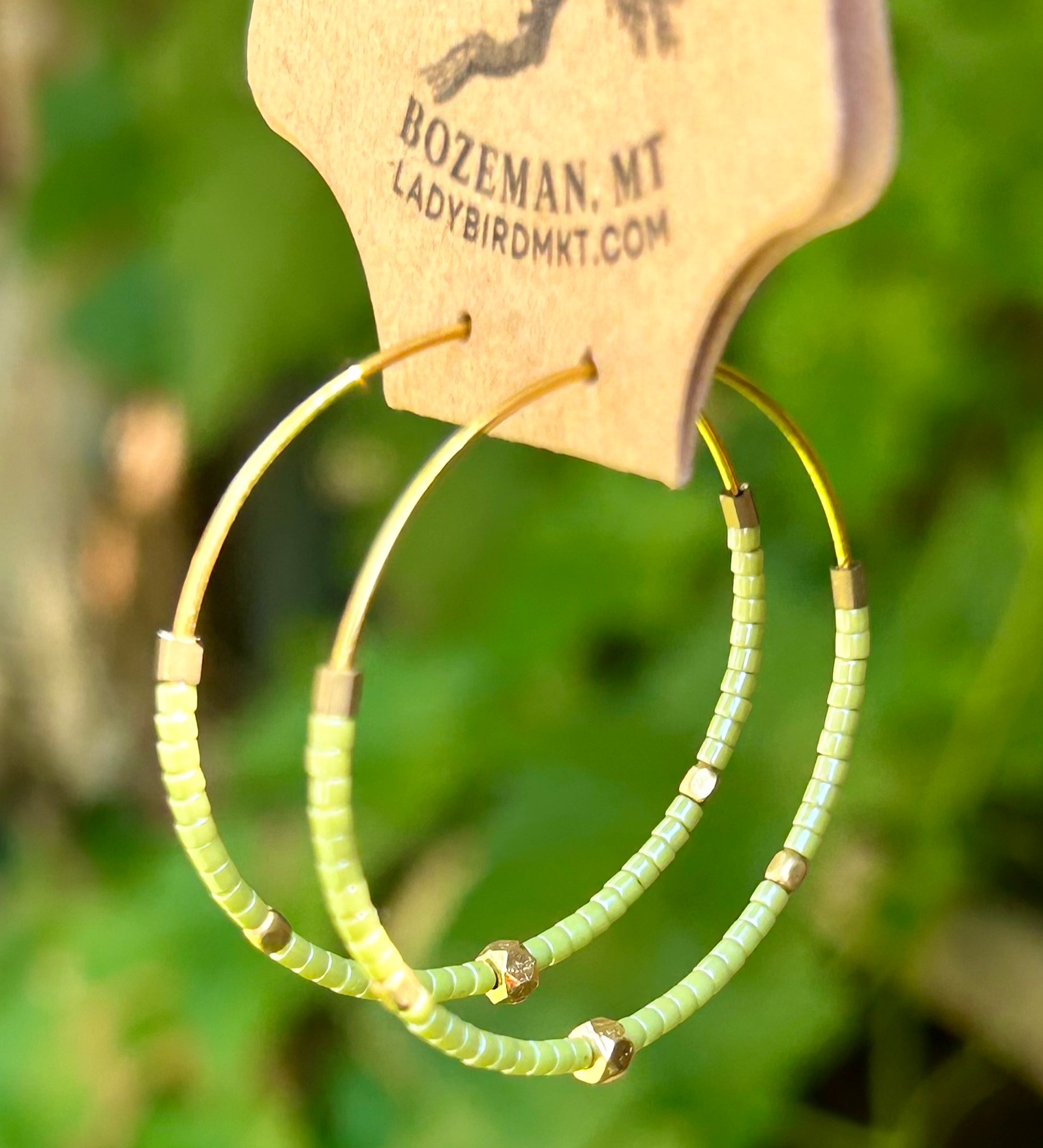 Pale green and gold beaded hoop earrings featuring Miyuki Delica seed beads and metallic gold lattice beads, elegantly designed for bohemian style.