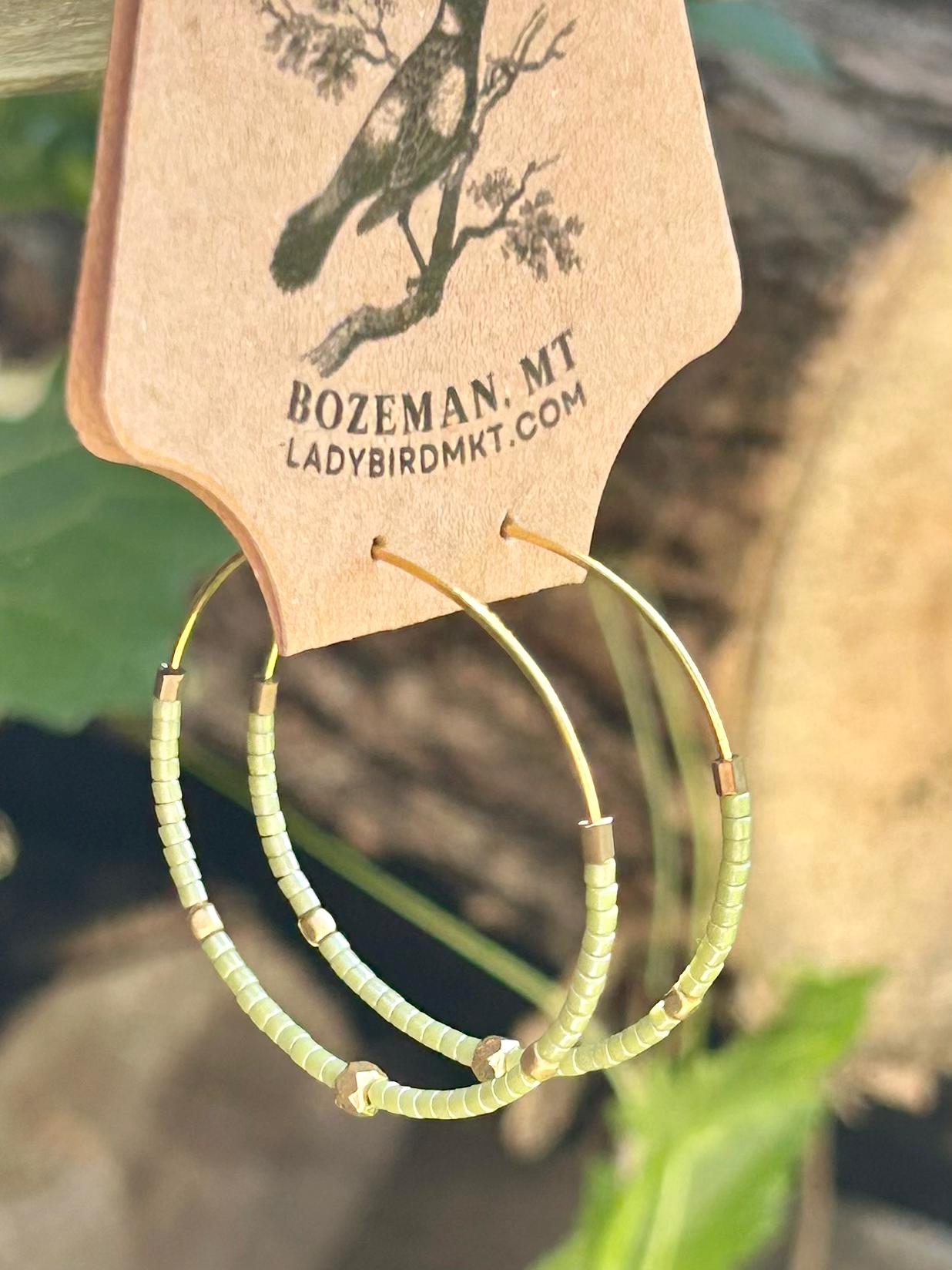 Pale green and gold beaded hoop earrings featuring Miyuki Delica seed beads and metallic gold lattice beads, elegantly designed for bohemian style.