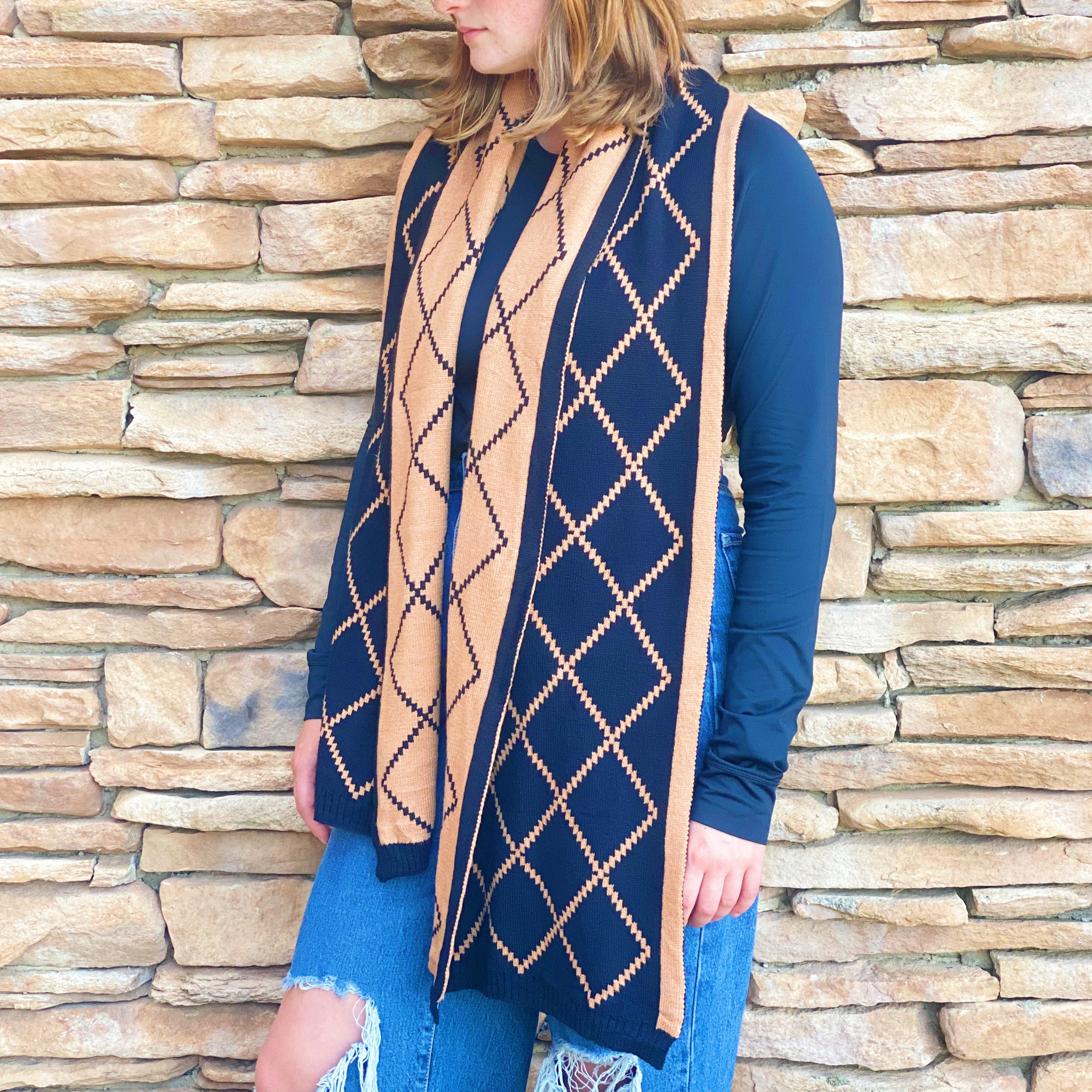 A cozy Paris Class Knit Scarf featuring a diamond pattern, showcasing its soft texture and reversible design in contrasting colors.