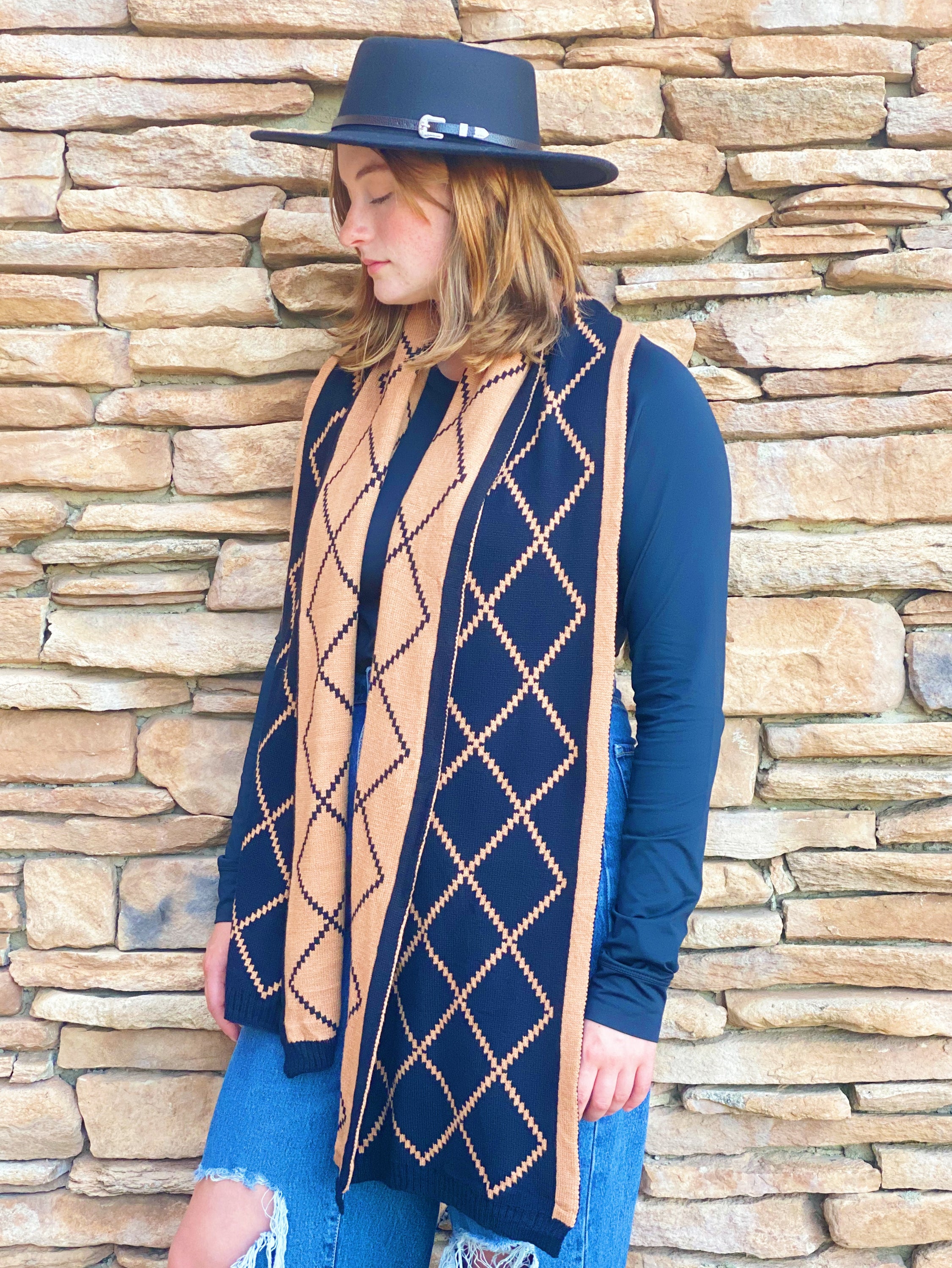 A cozy Paris Class Knit Scarf featuring a diamond pattern, showcasing its soft texture and reversible design in contrasting colors.