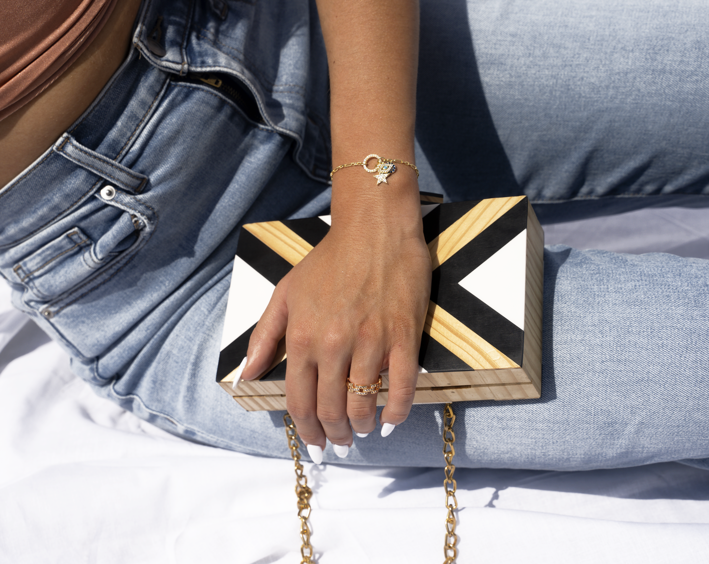 PARISA Charm Bracelet featuring three unique charms: a royal blue medallion, an evil eye, and a glittering star, crafted from 925 Sterling Silver with yellow gold plating.