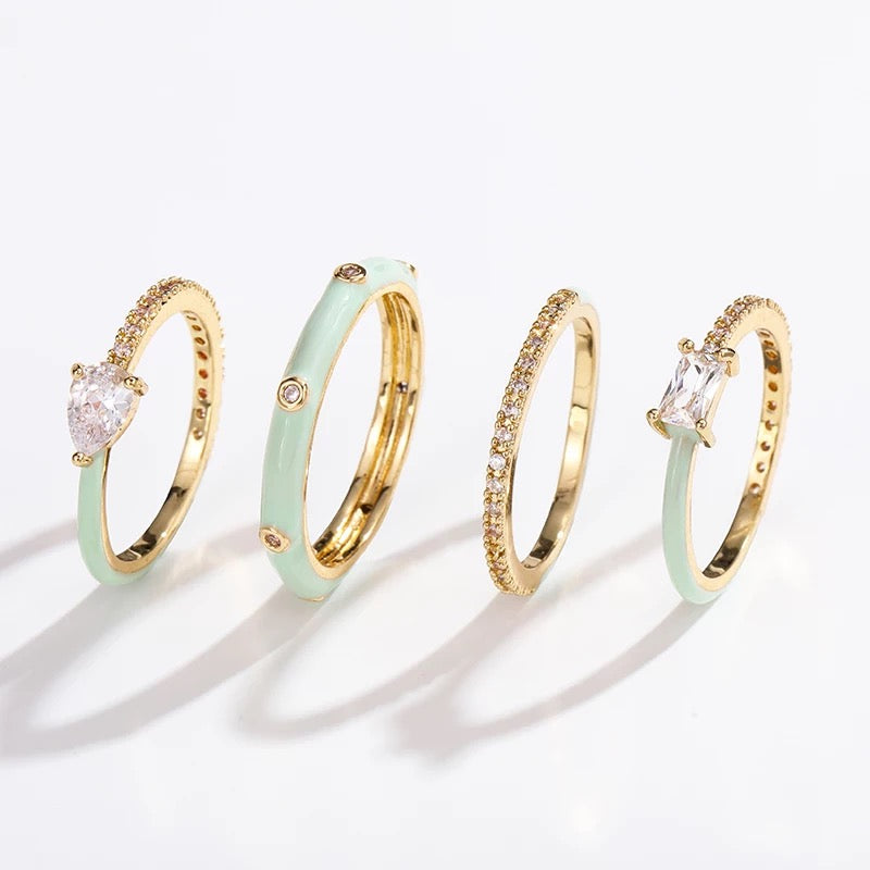 Pastel Glam Ring Set of 4 featuring colorful enamel and rhinestone details, showcasing three size 5 rings and one size 7 ring.