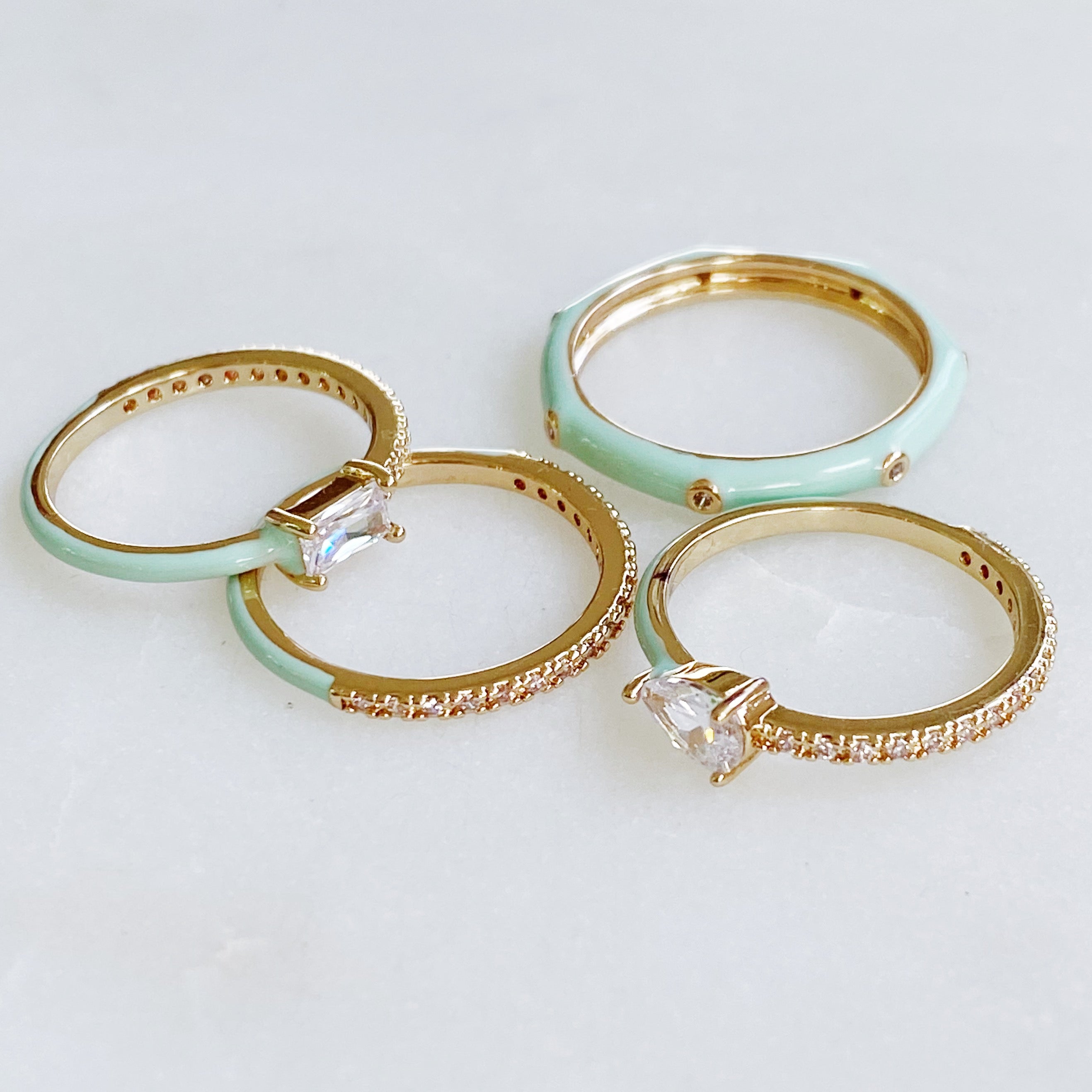 Pastel Glam Ring Set of 4 featuring colorful enamel and rhinestone details, showcasing three size 5 rings and one size 7 ring.