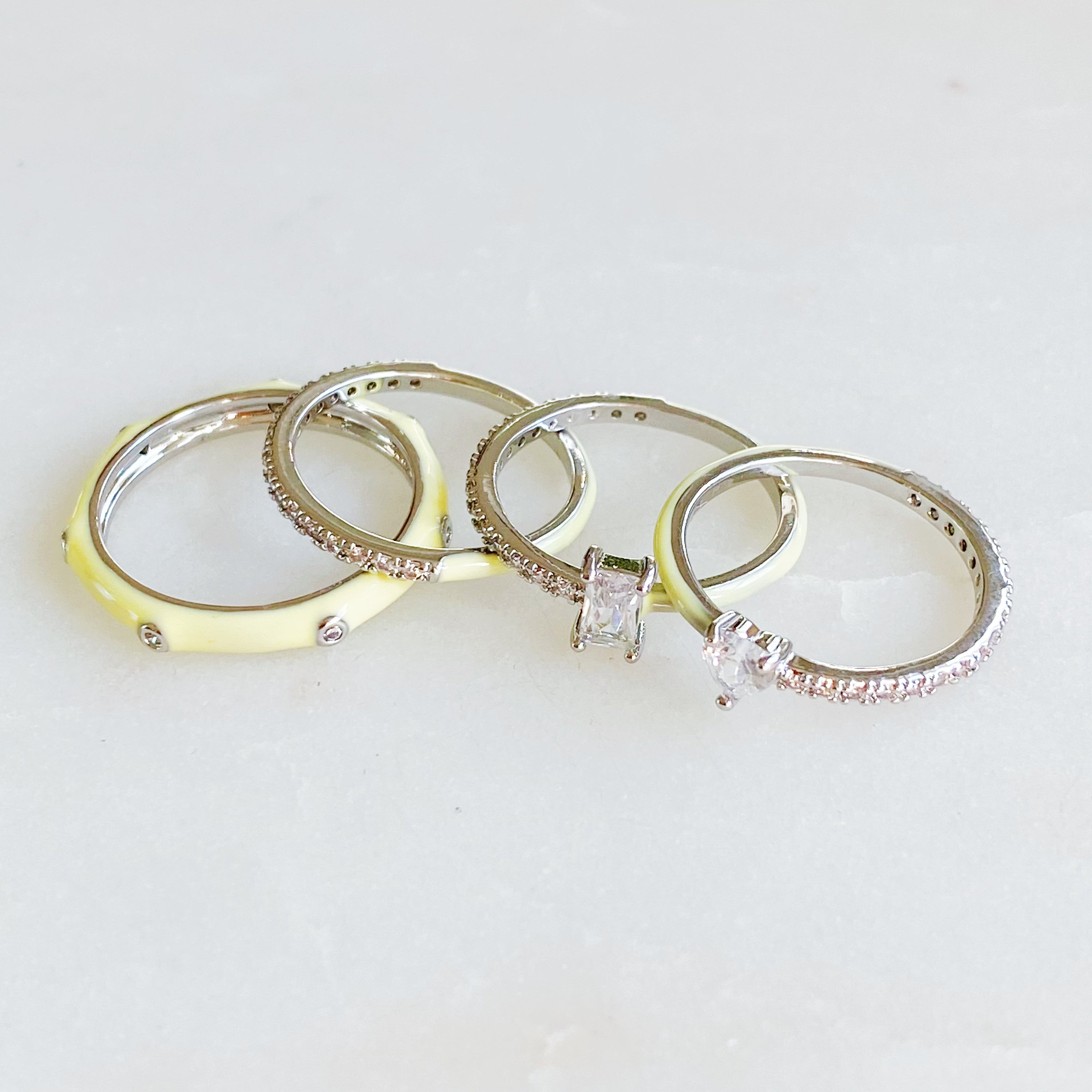 Pastel Glam Ring Set of 4 featuring colorful enamel and rhinestone details, showcasing three size 5 rings and one size 7 ring.