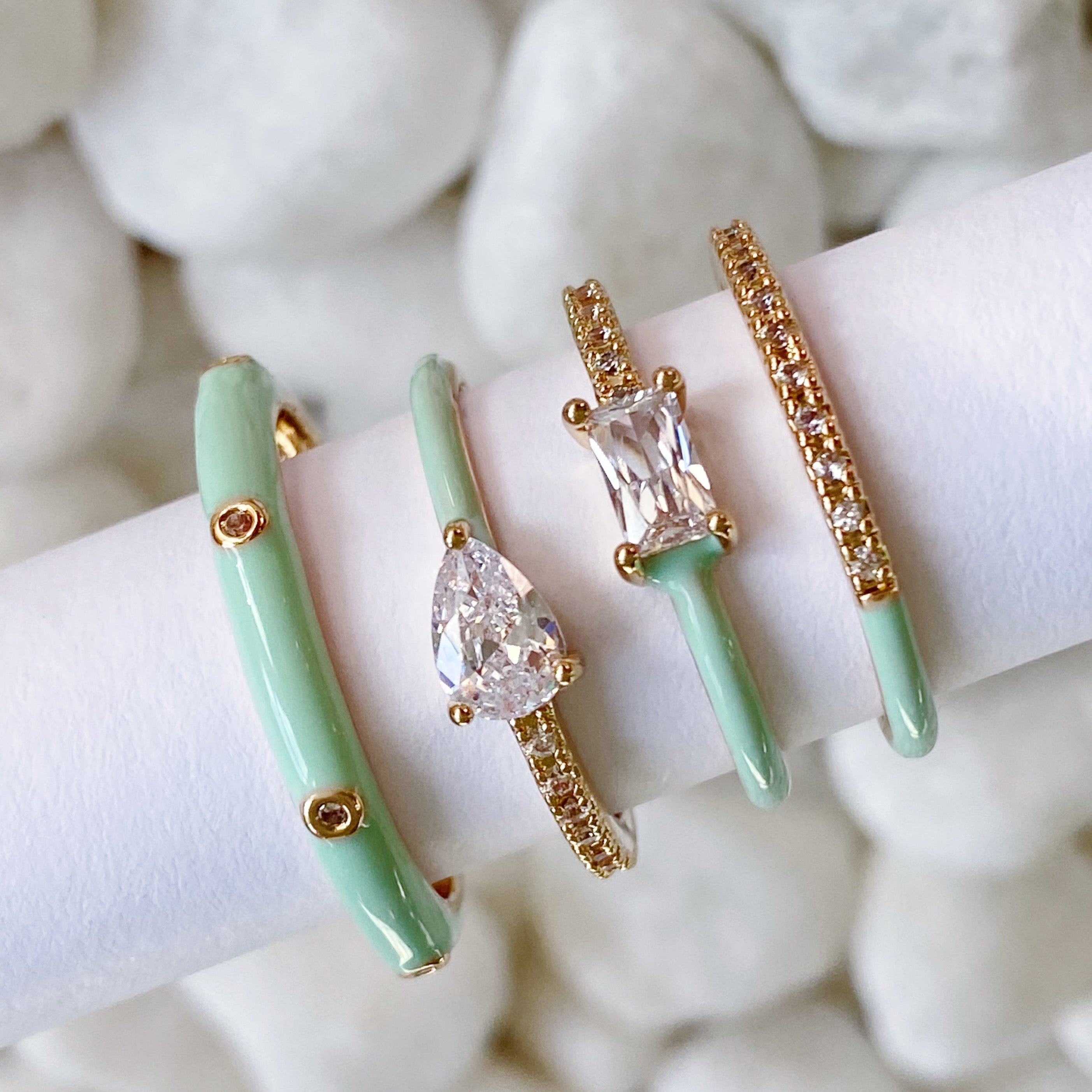 Pastel Glam Ring Set of 4 featuring colorful enamel and rhinestone details, showcasing three size 5 rings and one size 7 ring.