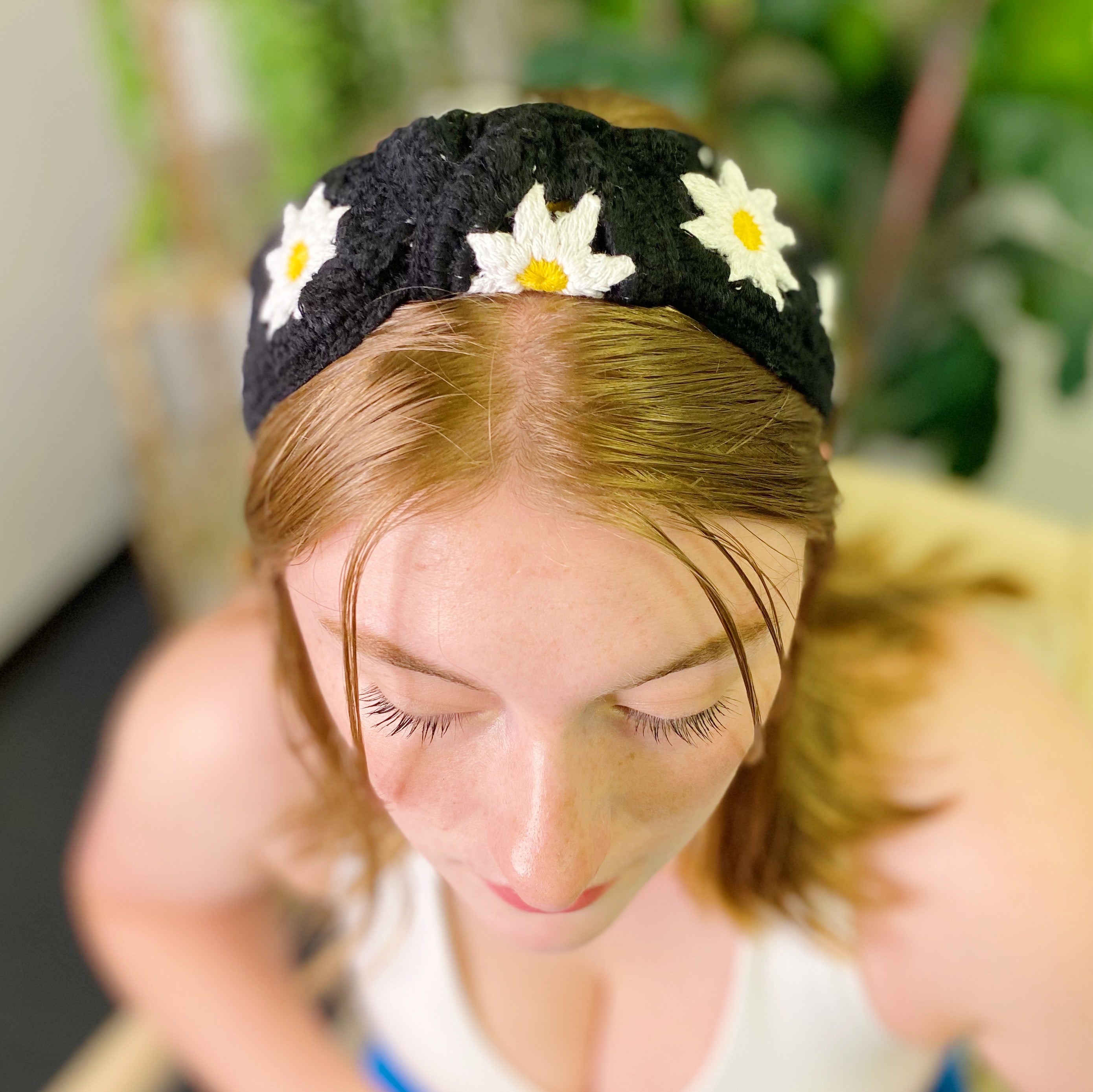 A colorful patchwork crochet headband with soft edges, perfect for everyday wear.