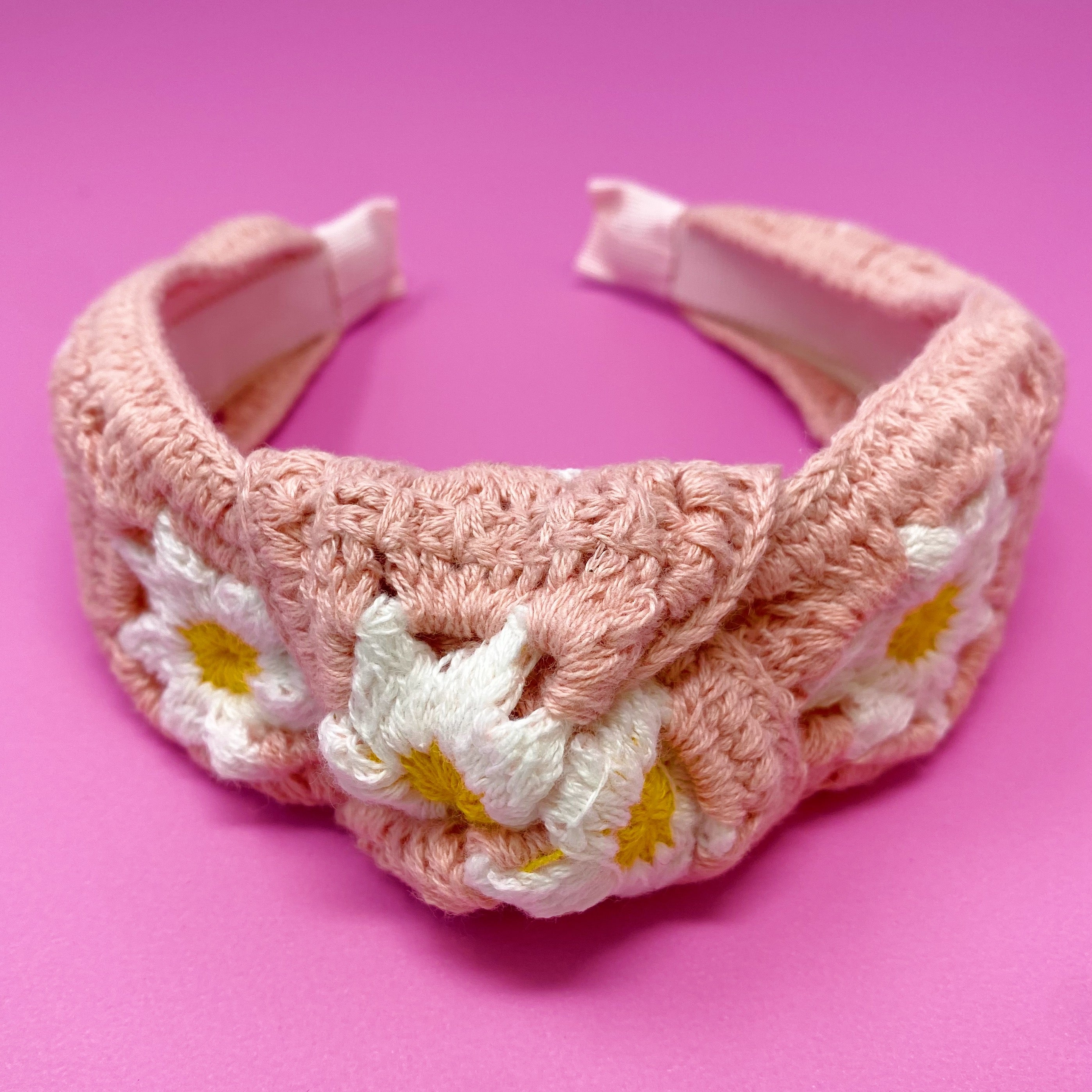 A colorful patchwork crochet headband with soft edges, perfect for everyday wear.